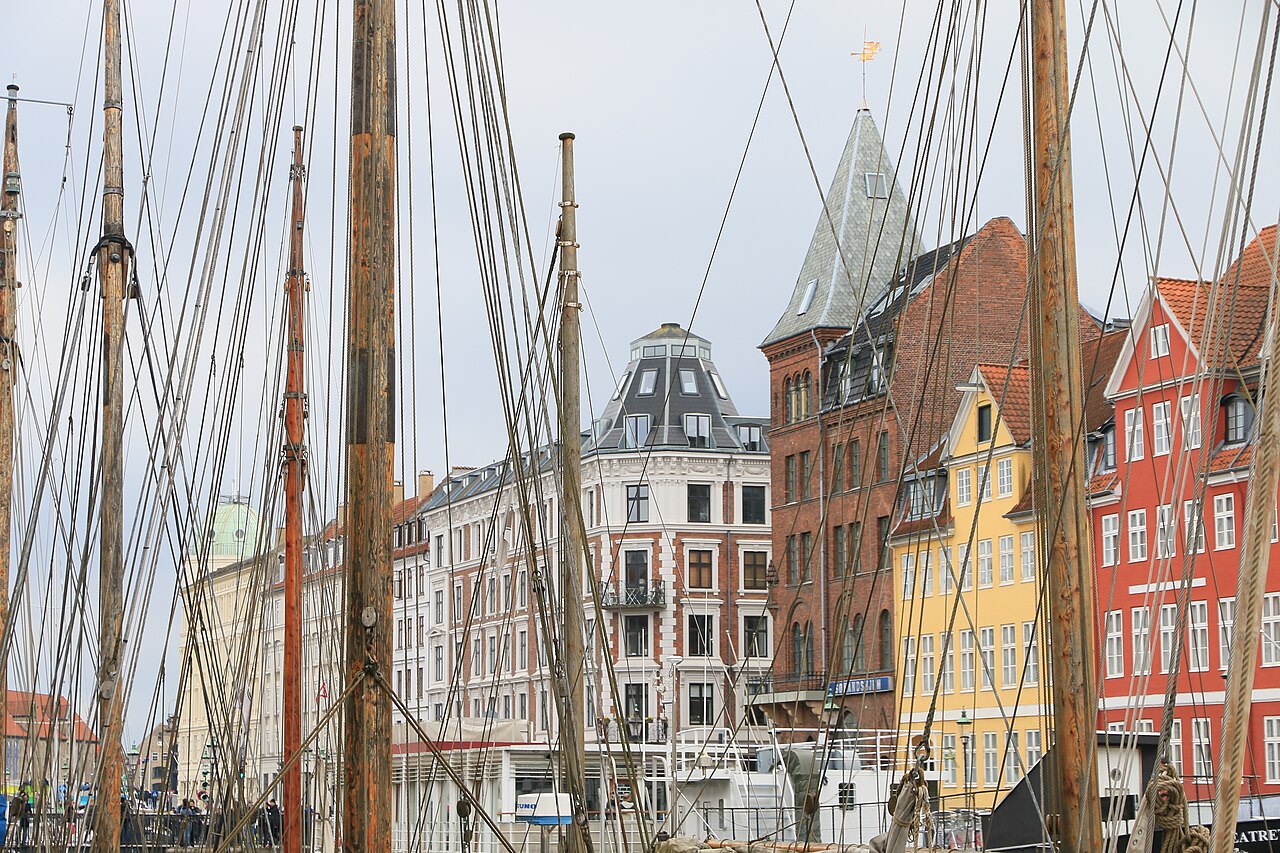 Tall painted houses and boat masts along the Nyhavn canal in Copenhagen