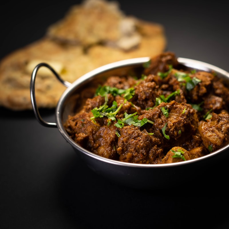 A stew of meat and vegetables in a metal bowl