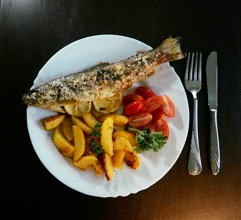 A whole roasted fish served with potatoes