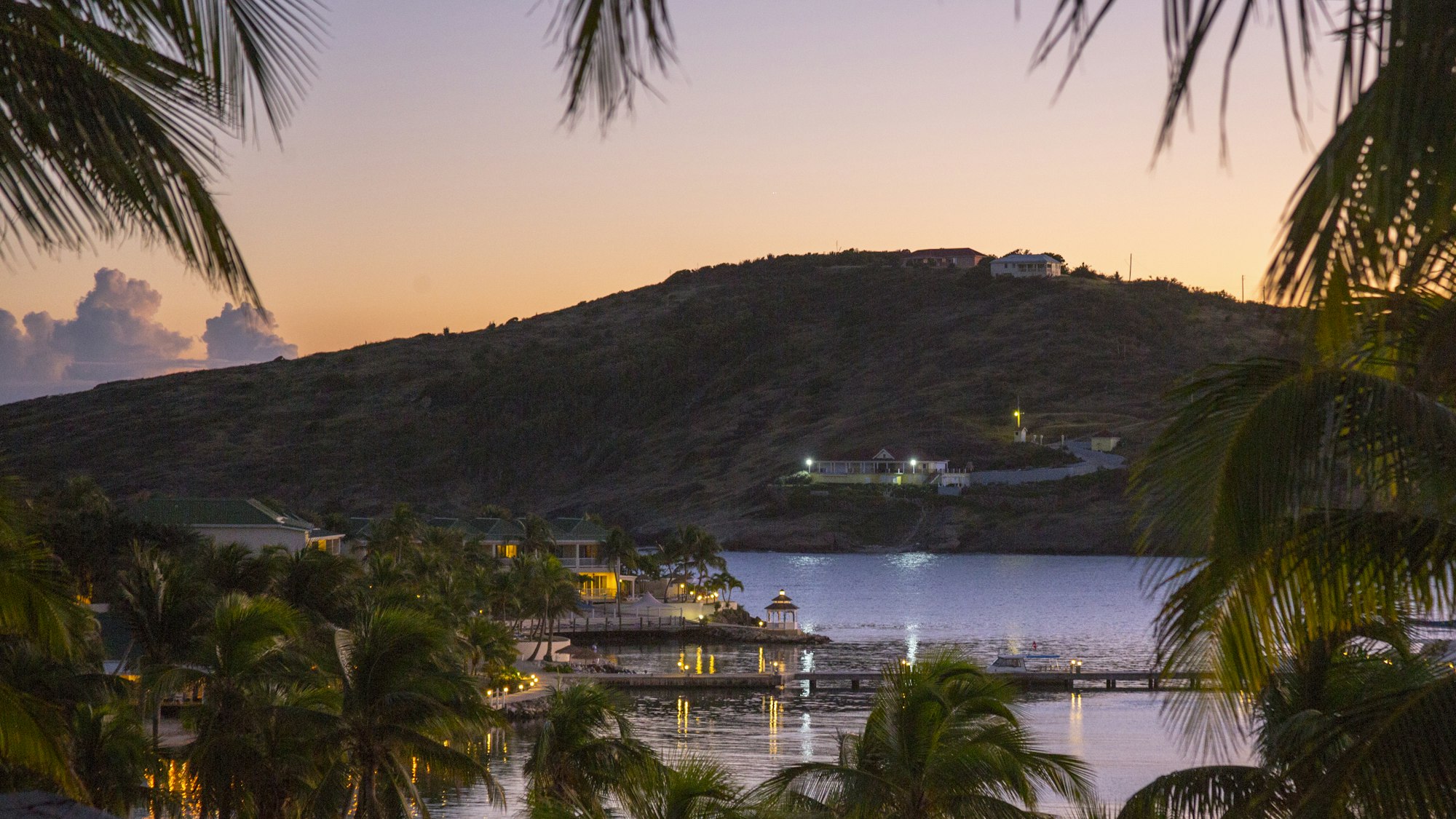 Calm water below a hillside of houses at Mamora Bay, Antigua