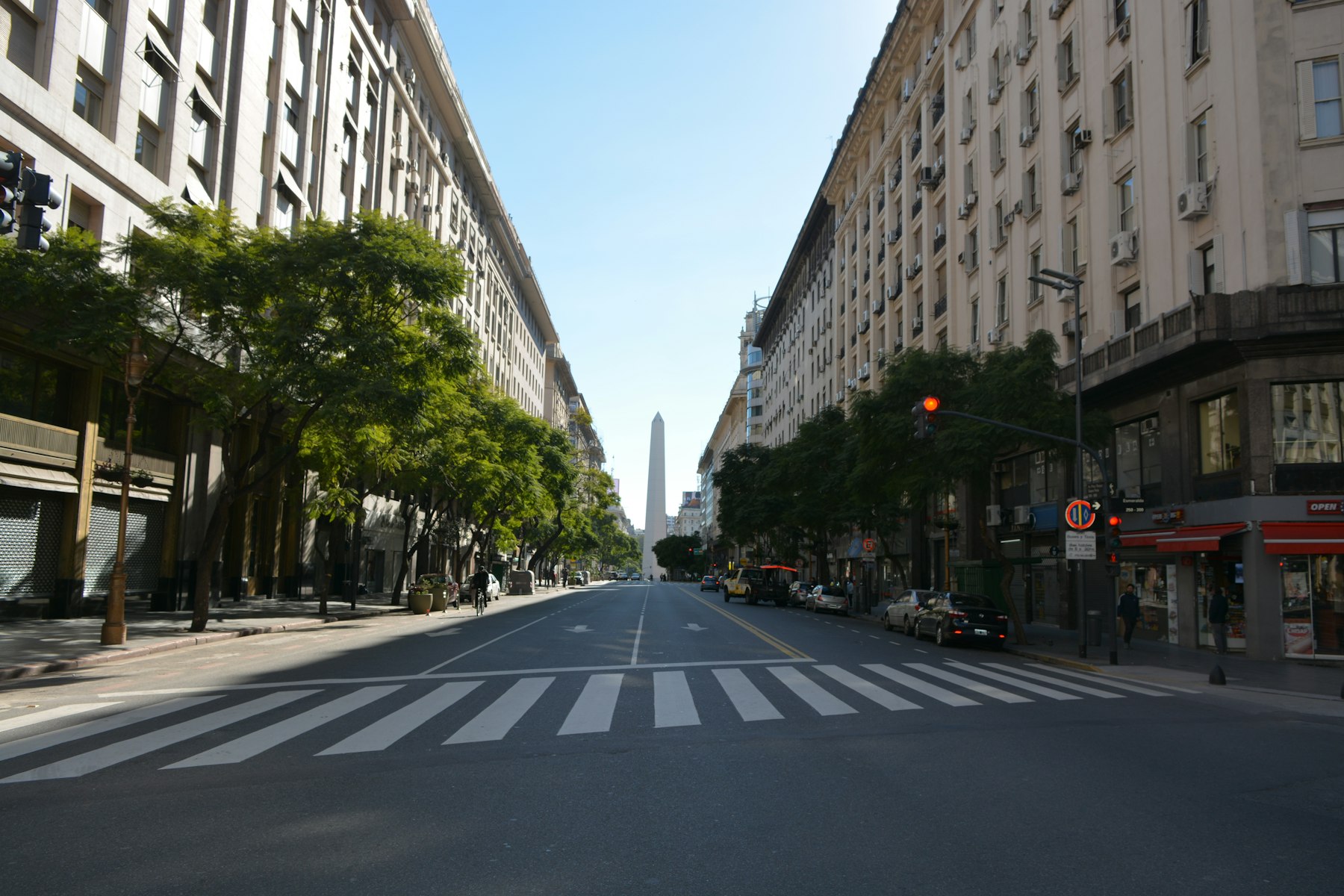 A wide avenue in central Buenos Aires with the Obelisco in the distance