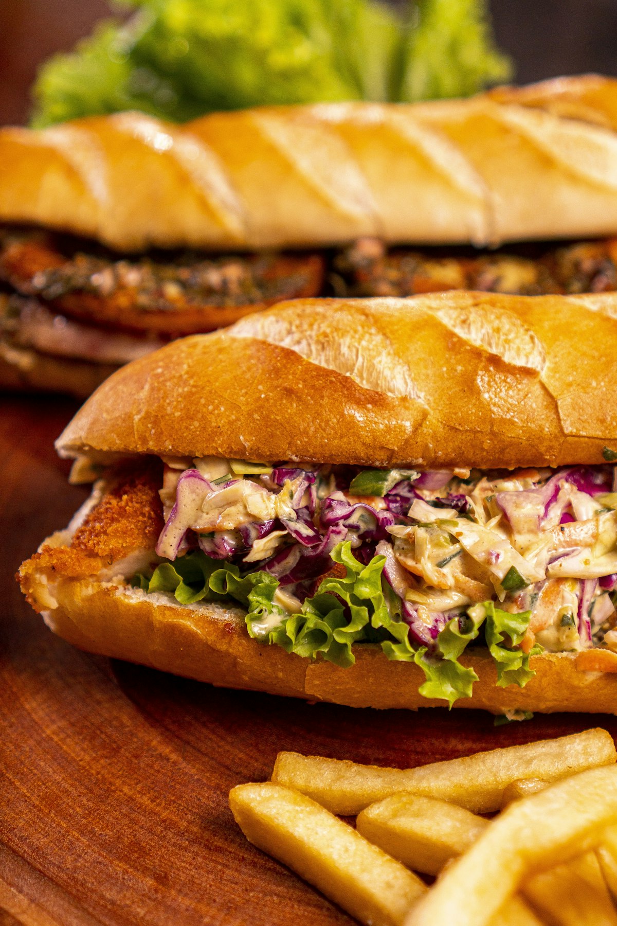 A crusty bread roll filled with a fried fillet and shredded cabbage slaw