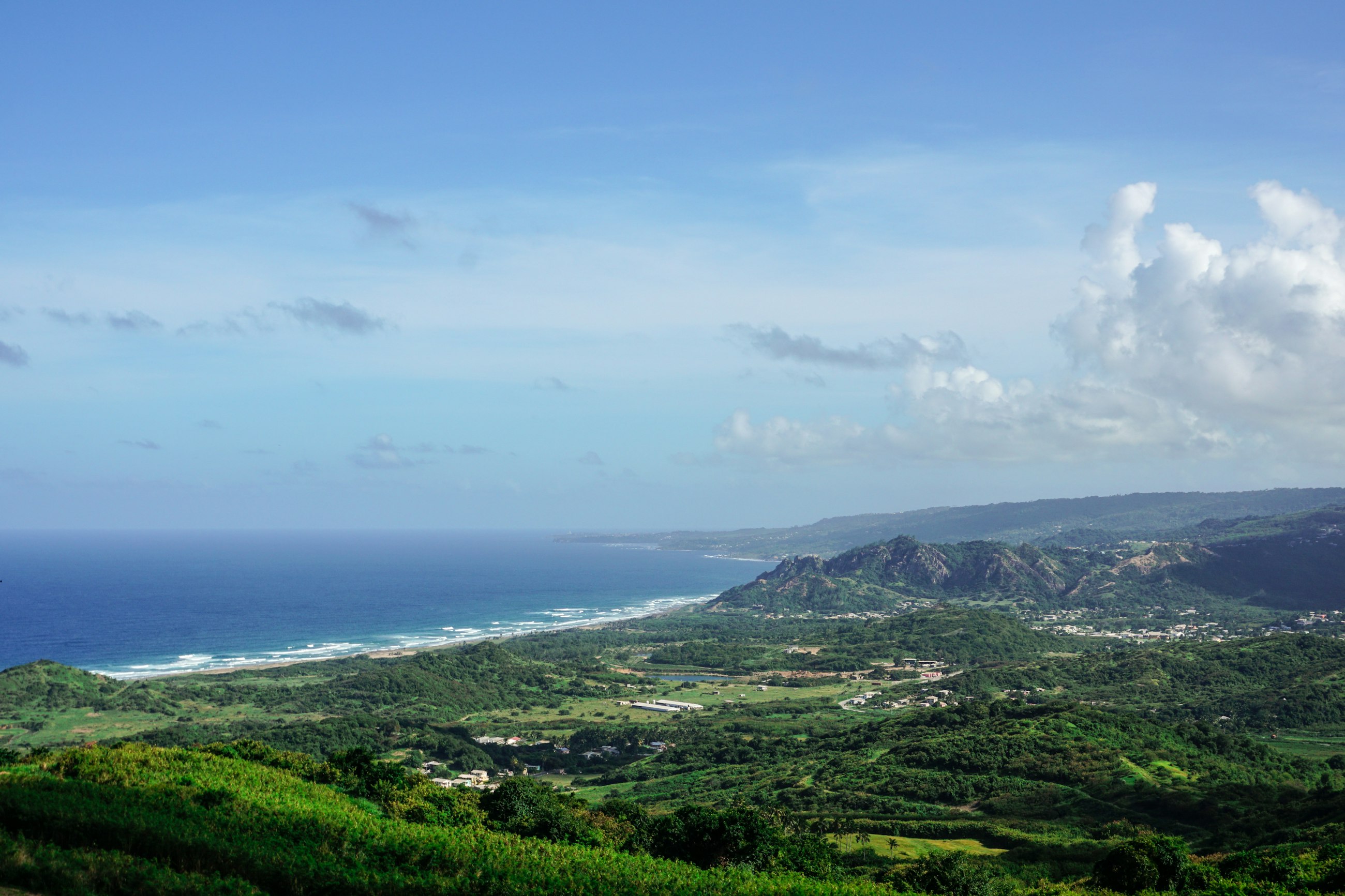 The view down over green fields and the Atlantic coast from Cherry Tree Hill in the Scotland District of Barbados