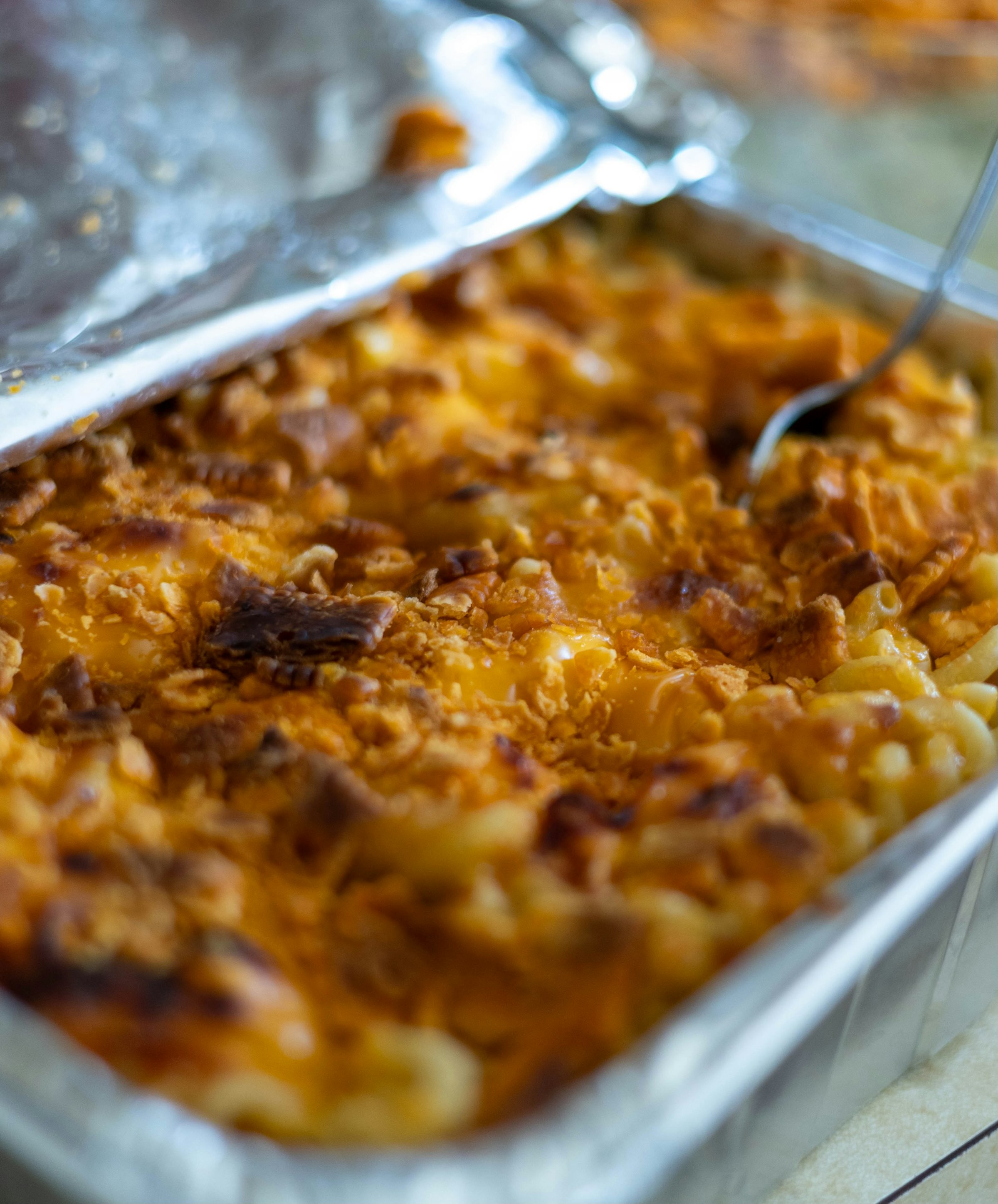 A thick baked macaroni cheese served as a slice on a plate