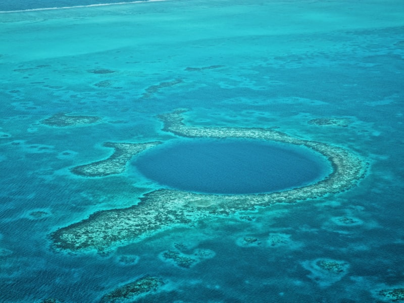The Great Blue Hole seen from the air as a dark circle in the reef off Belize