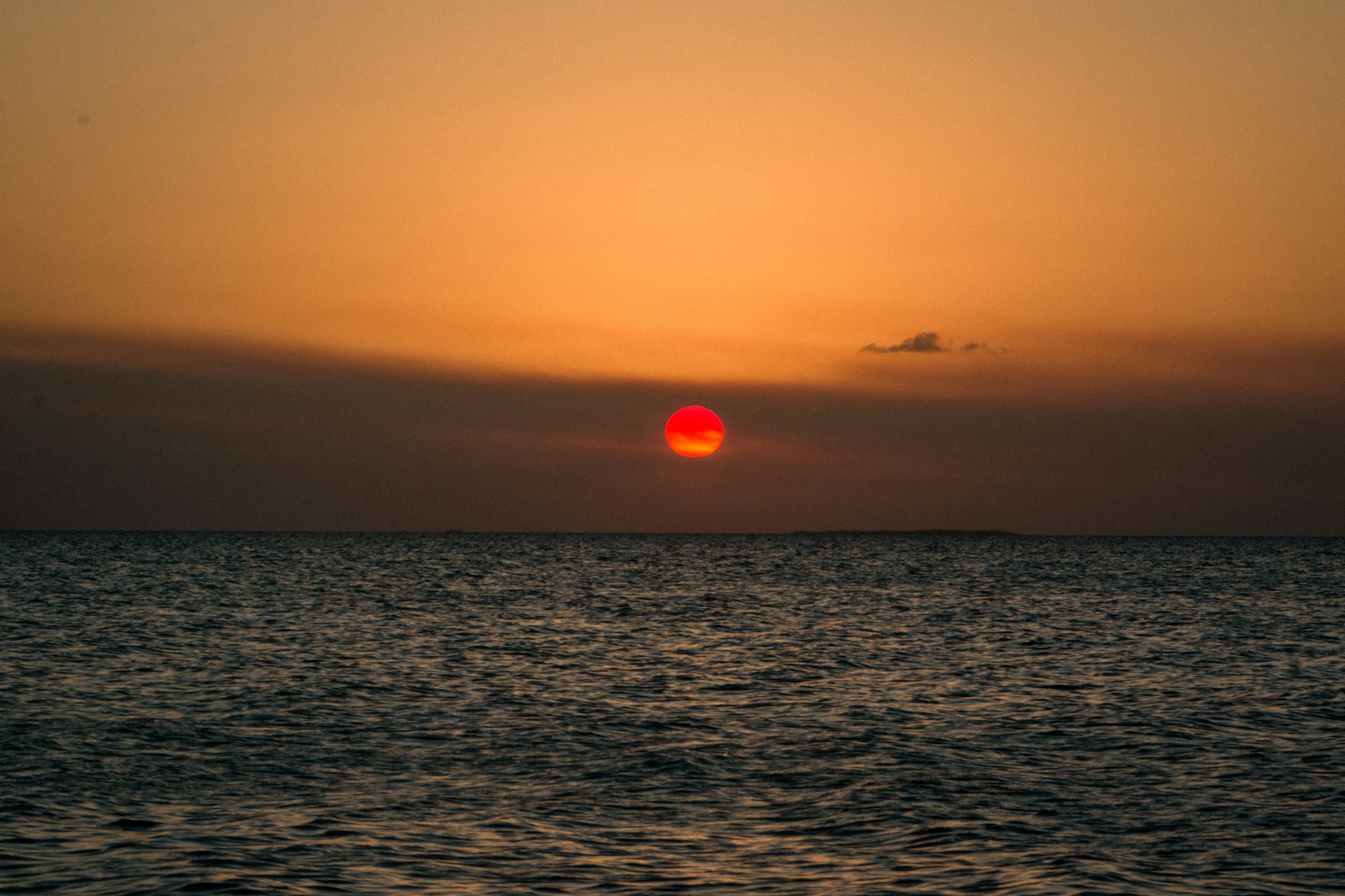 Sunset over the sea and low clouds seen from San Pedro, Belize