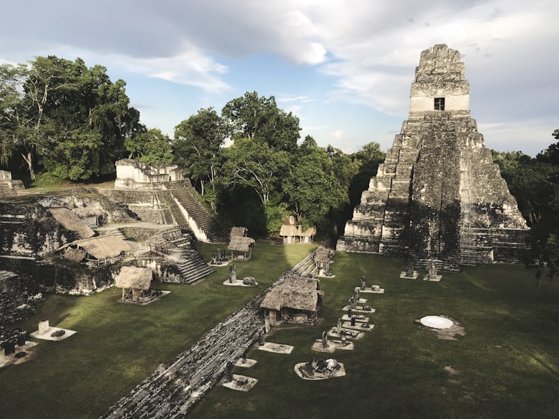 A stone Maya temple rising above the trees at Tikal in Guatemala