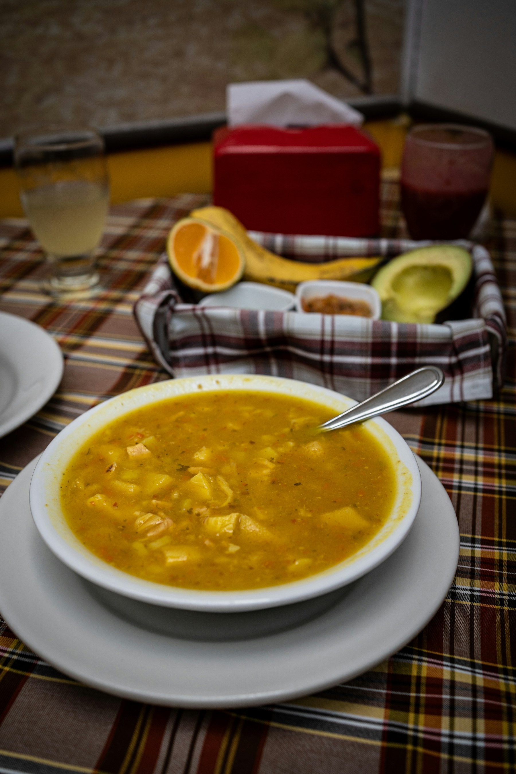 A bowl of Colombian ajiaco chicken and potato soup