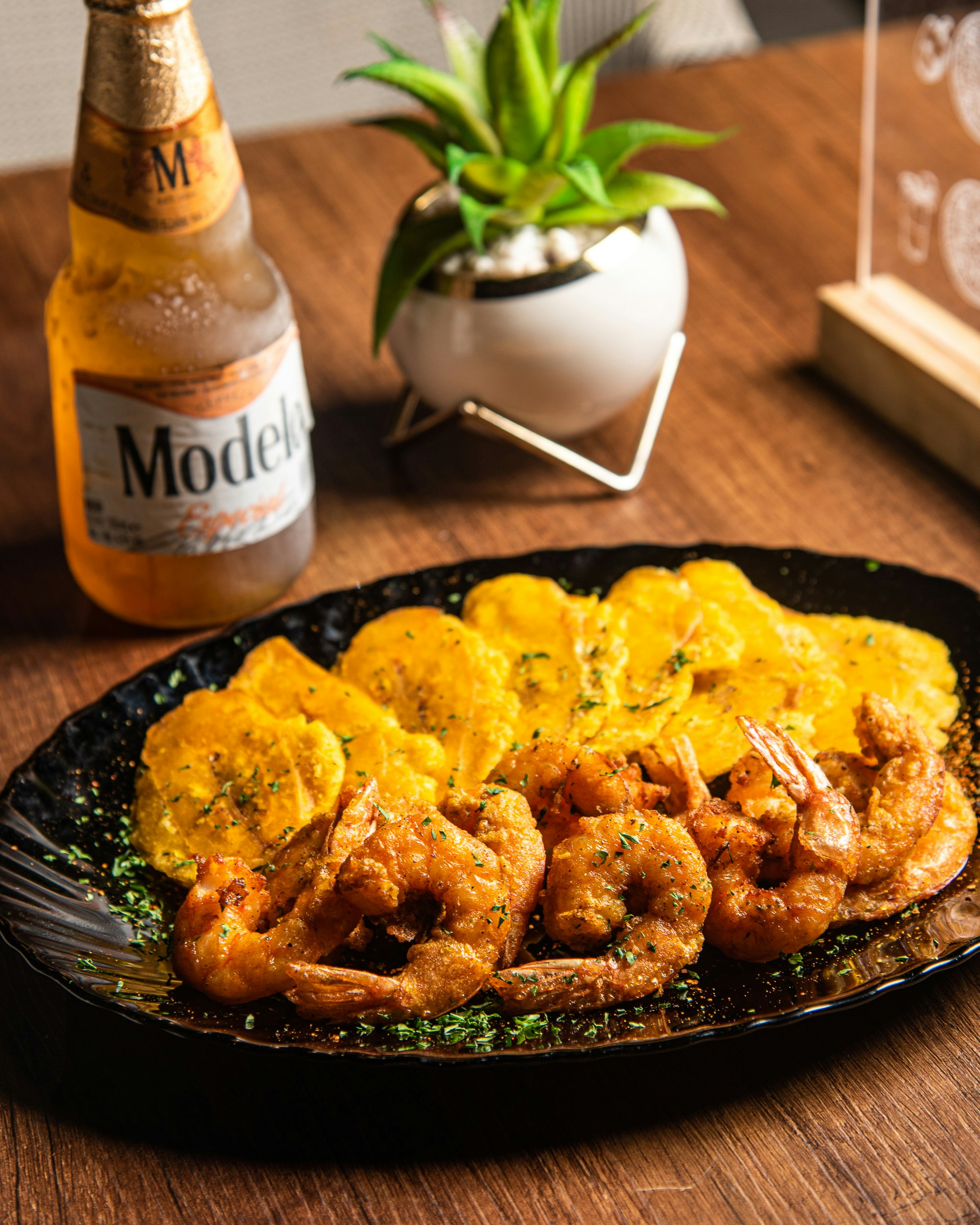 Golden patacones twice fried green plantain discs served with prawns