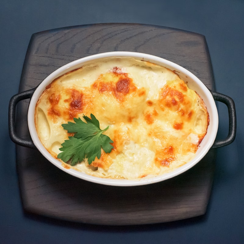 A baked cheese and meat casserole in a dish