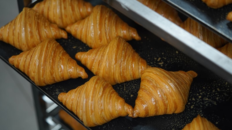 Golden crescent pastries on a baking tray