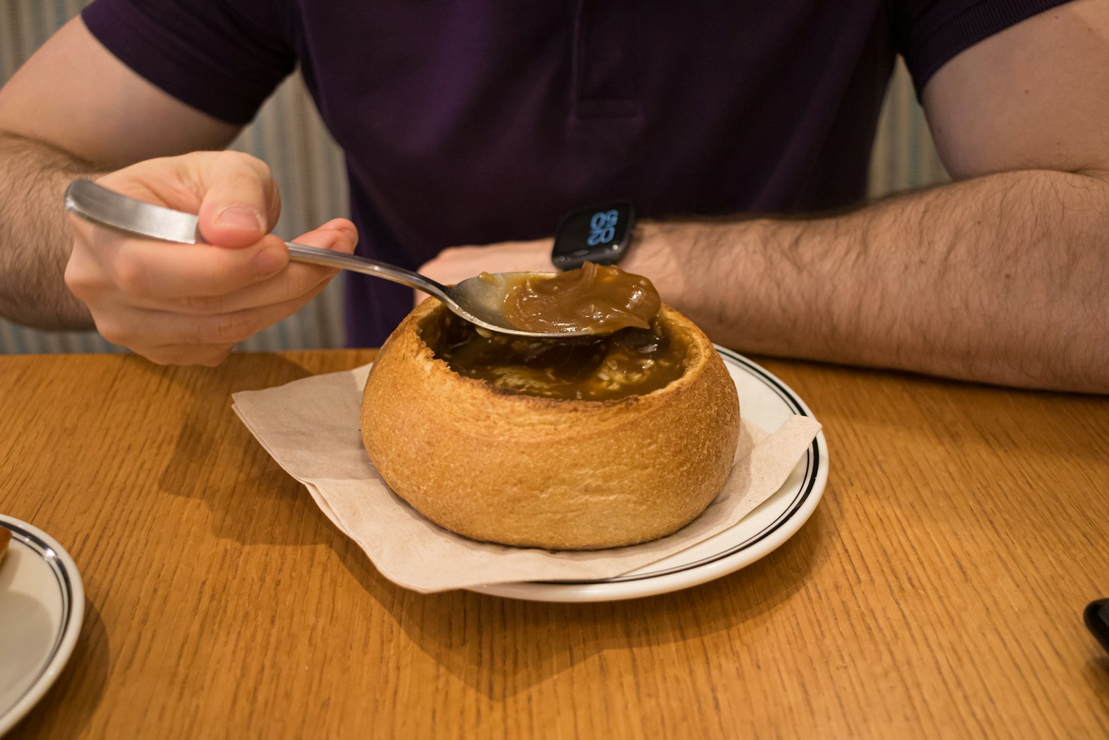 Beef goulash served inside a hollowed round loaf of bread