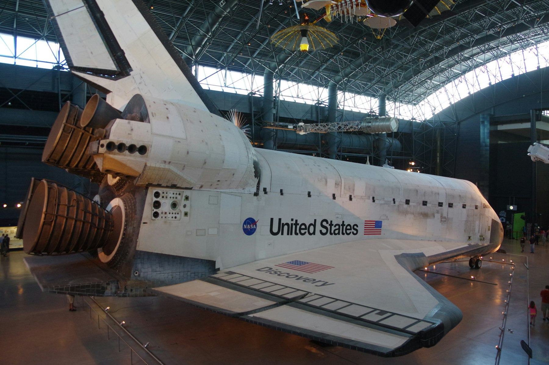 A retired NASA space shuttle displayed inside a large museum hangar