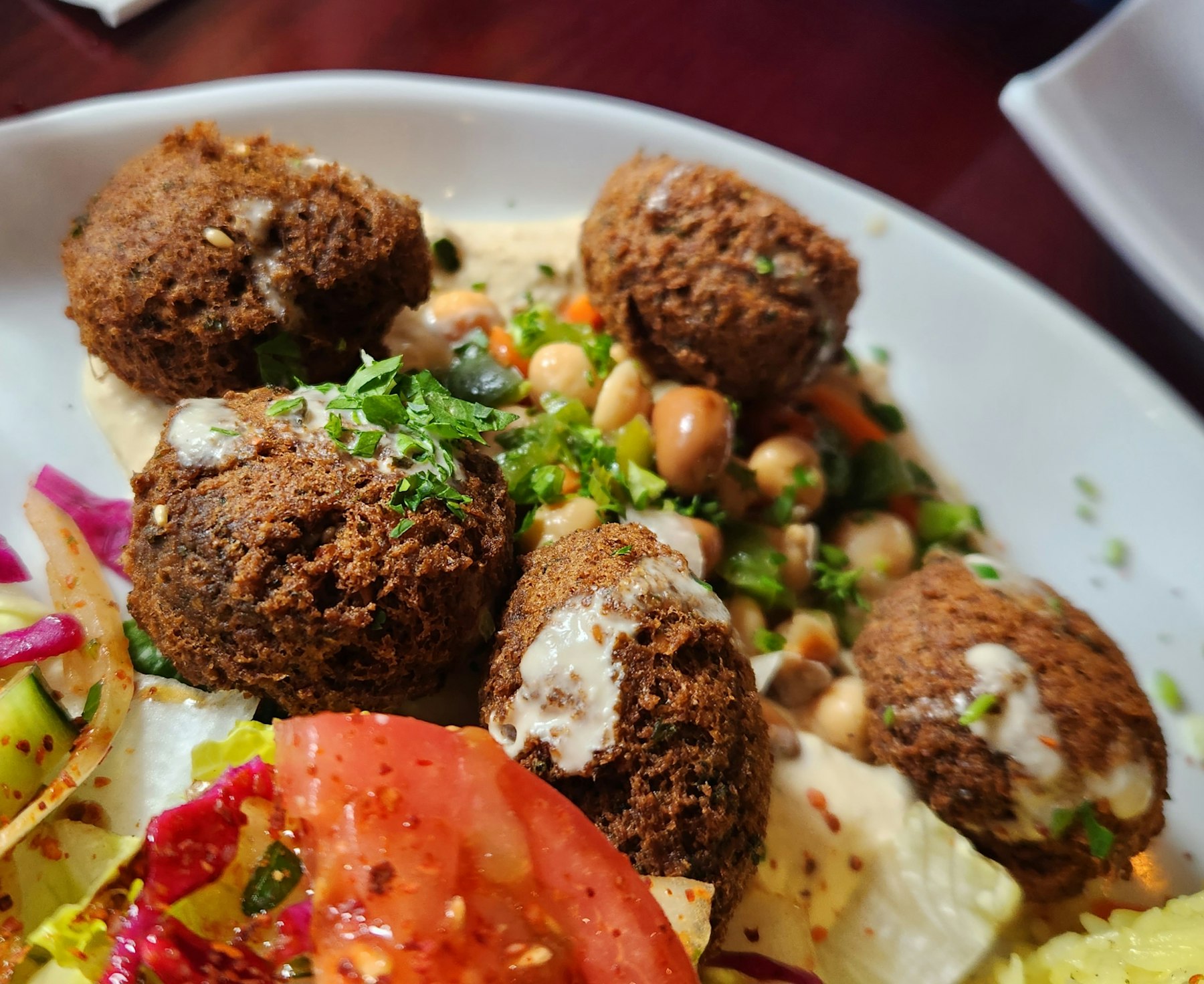 A plate of falafel with rice and salad, the Egyptian version is called taameya