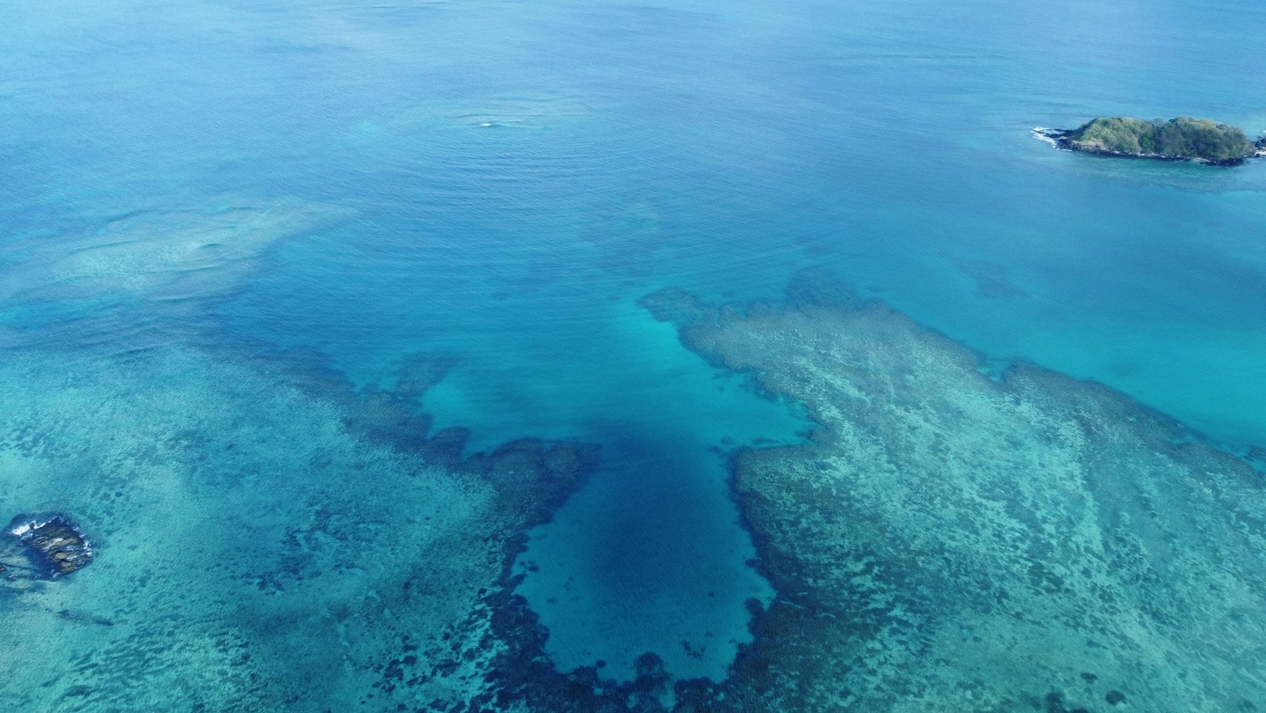 An aerial view of an island and lagoon at Oarsmans Bay in the Yasawa group of Fiji