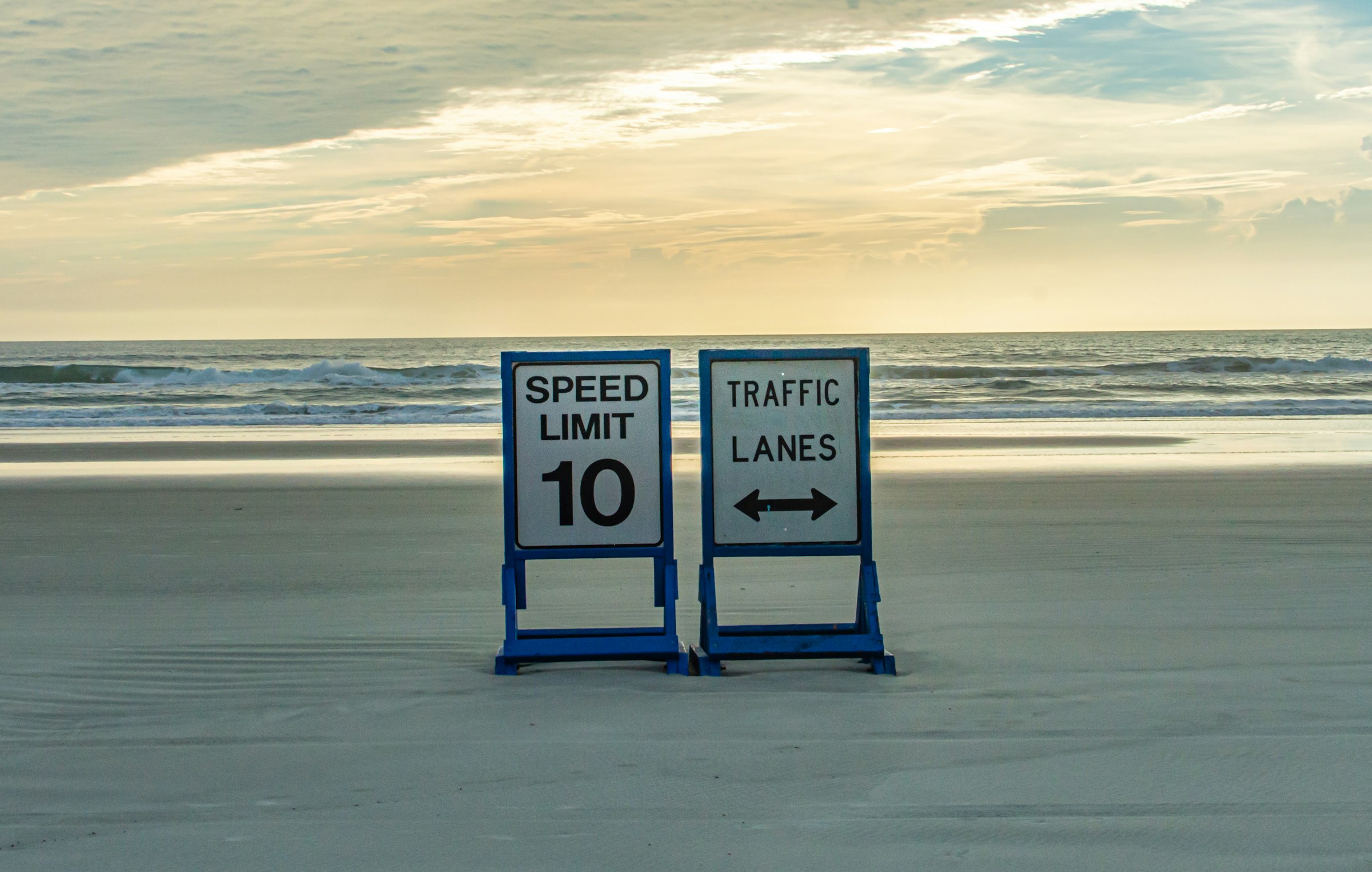 A ten mile per hour speed limit sign on the hard packed sand at Daytona Beach Florida