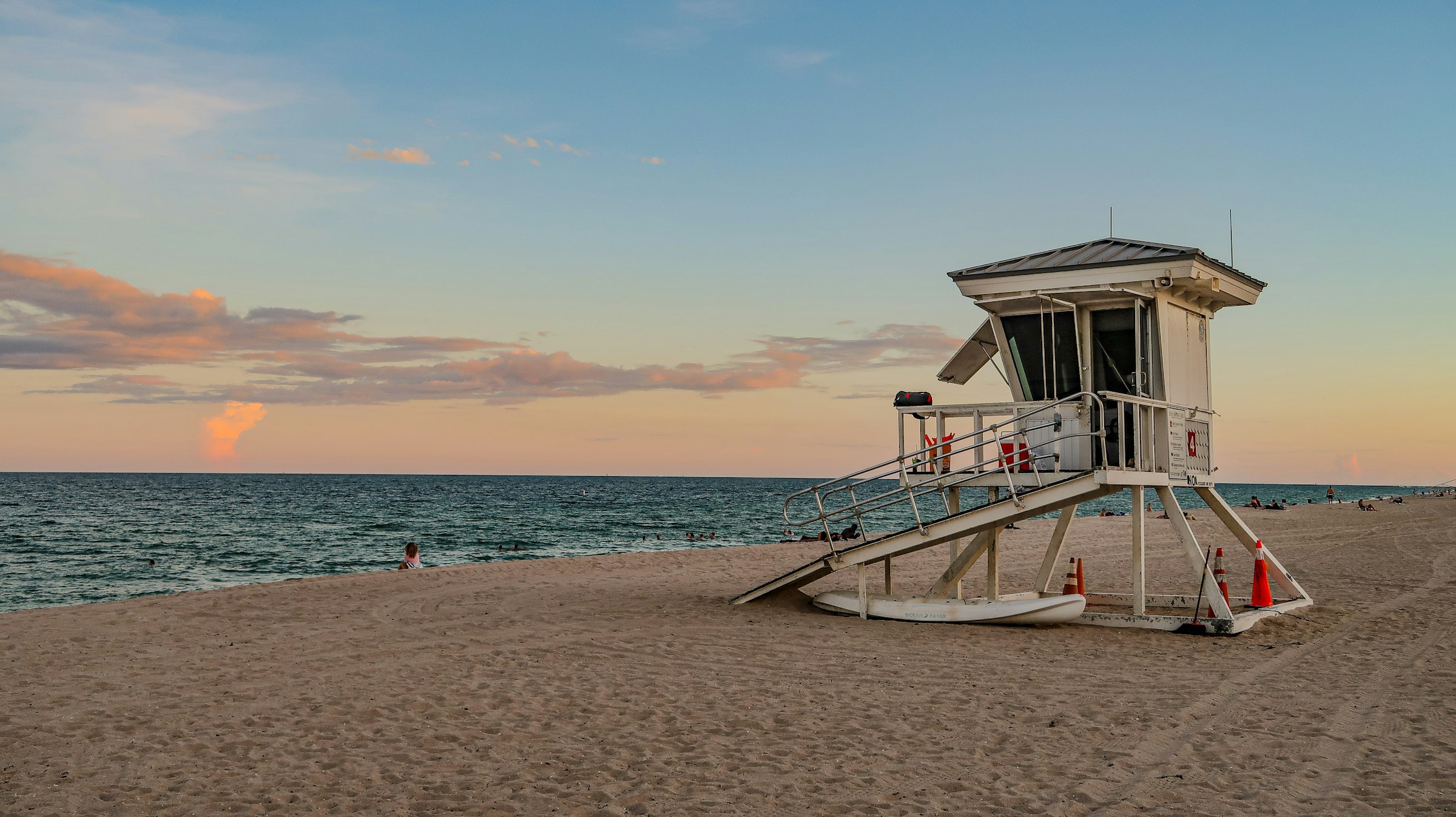 A white lifeguard tower on the sand at Miami Beach Florida at sunrise