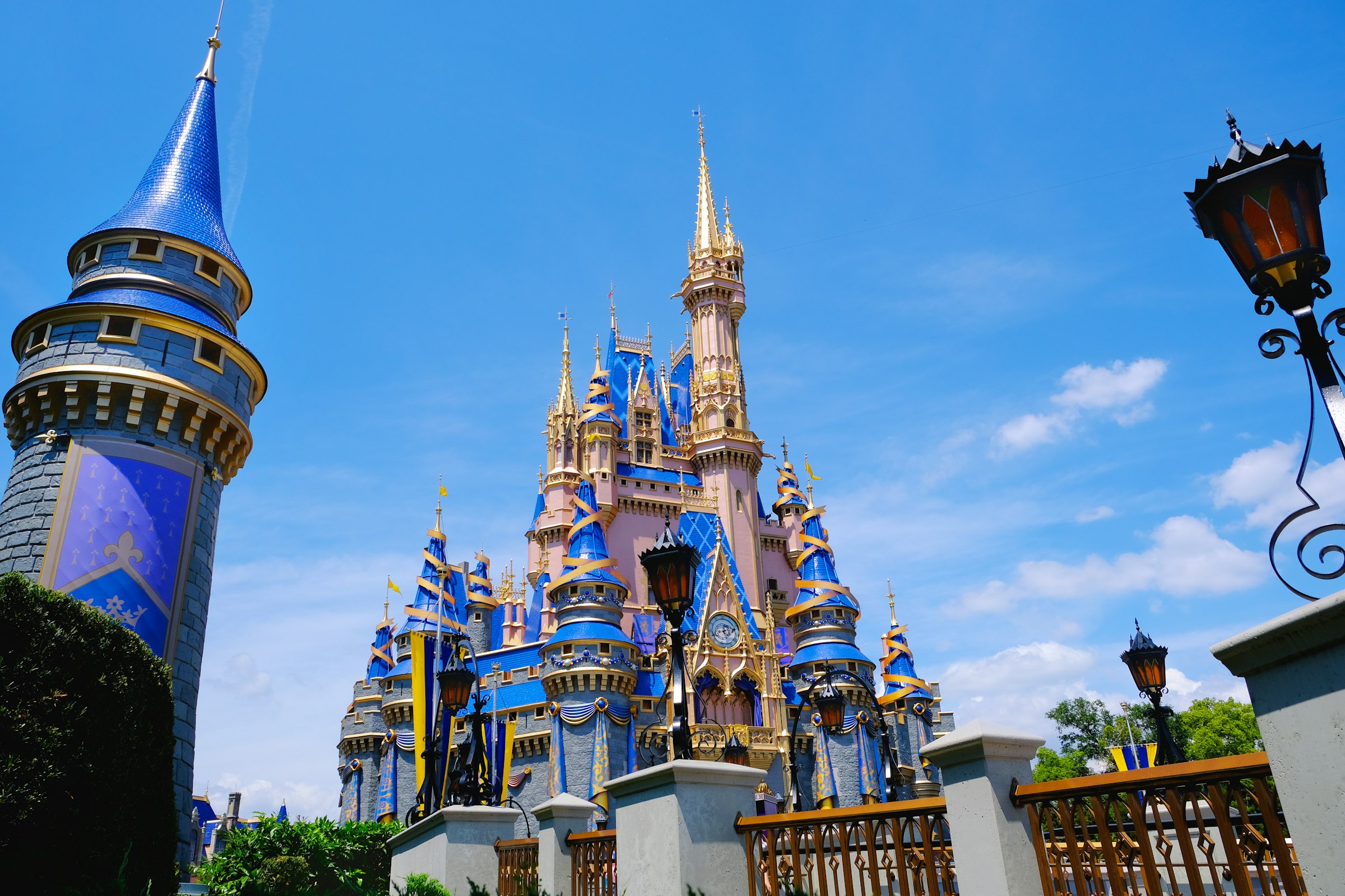 Cinderella Castle lit against a clear blue sky at Magic Kingdom