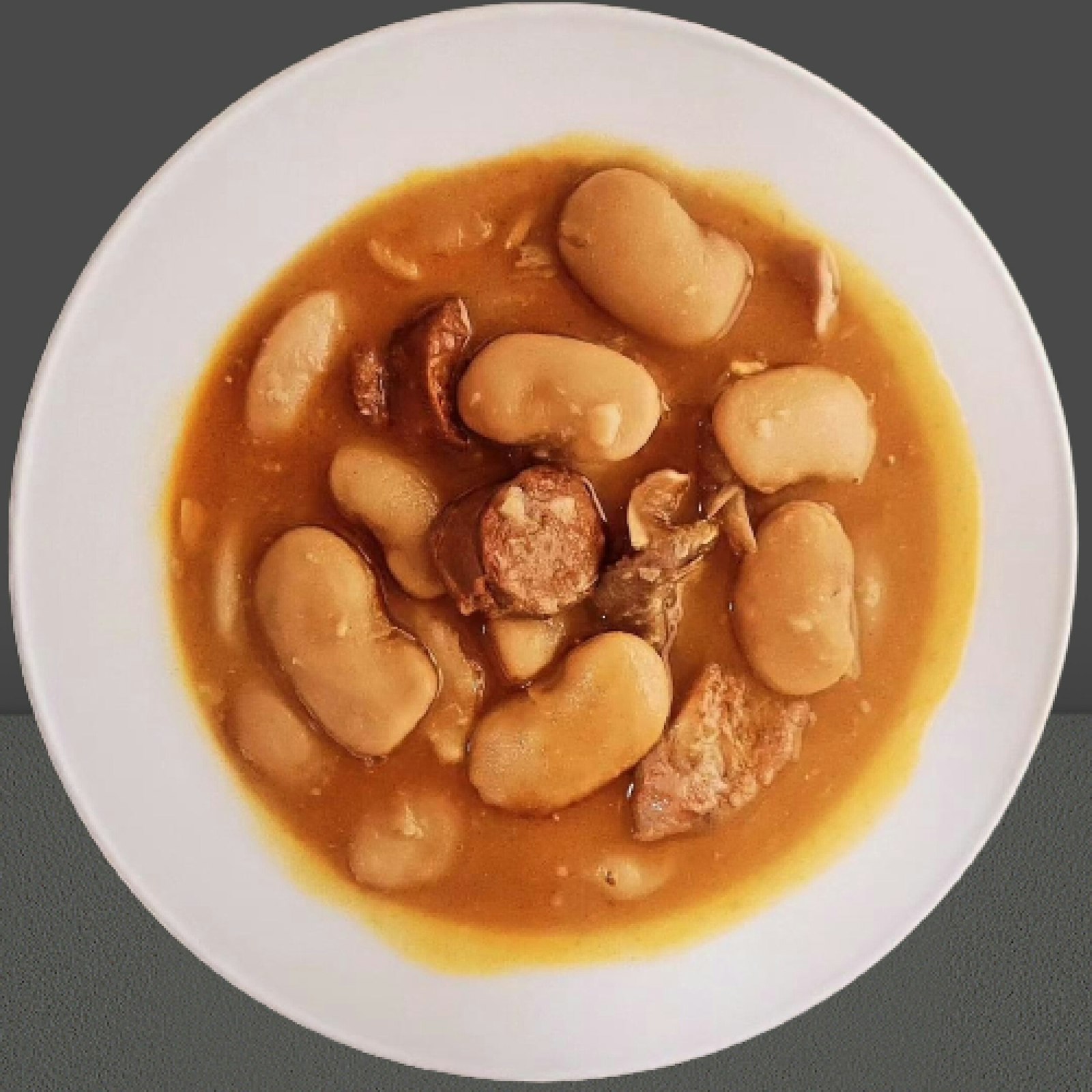 A plate of pork and bean stew