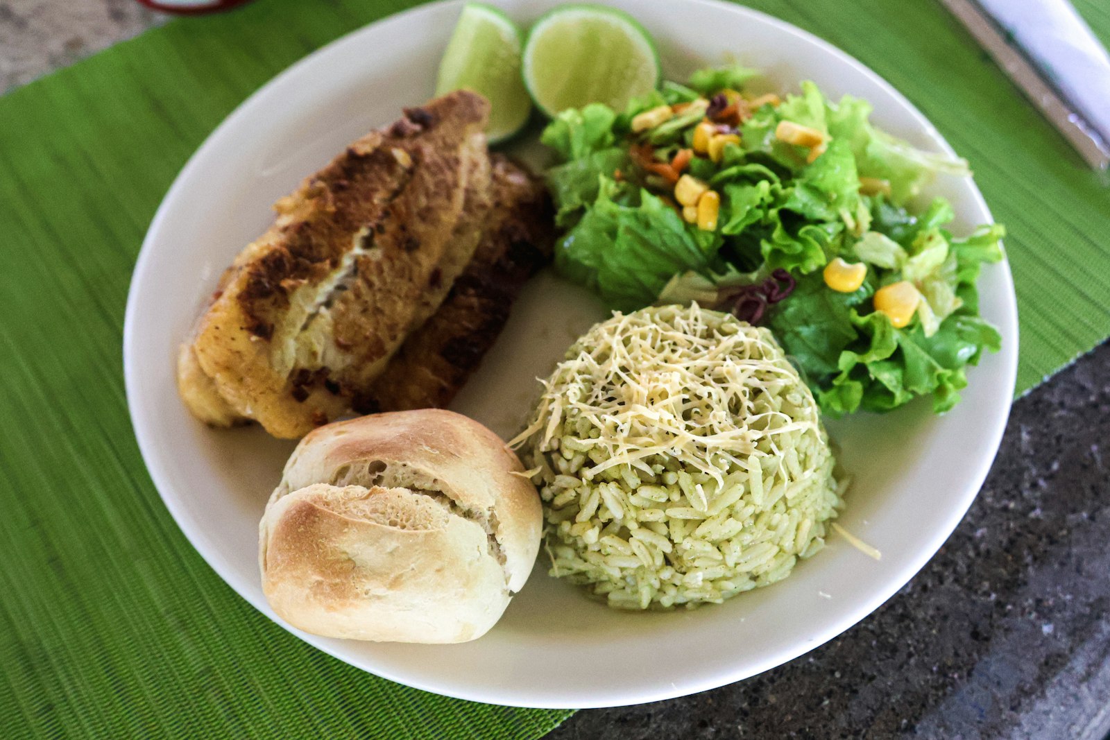 A plate of grilled white fish with rice