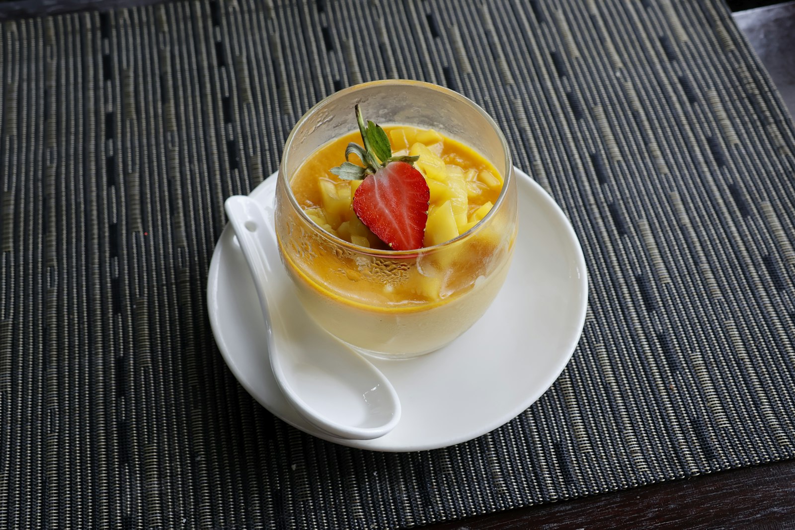 A tropical fruit dessert served in a glass