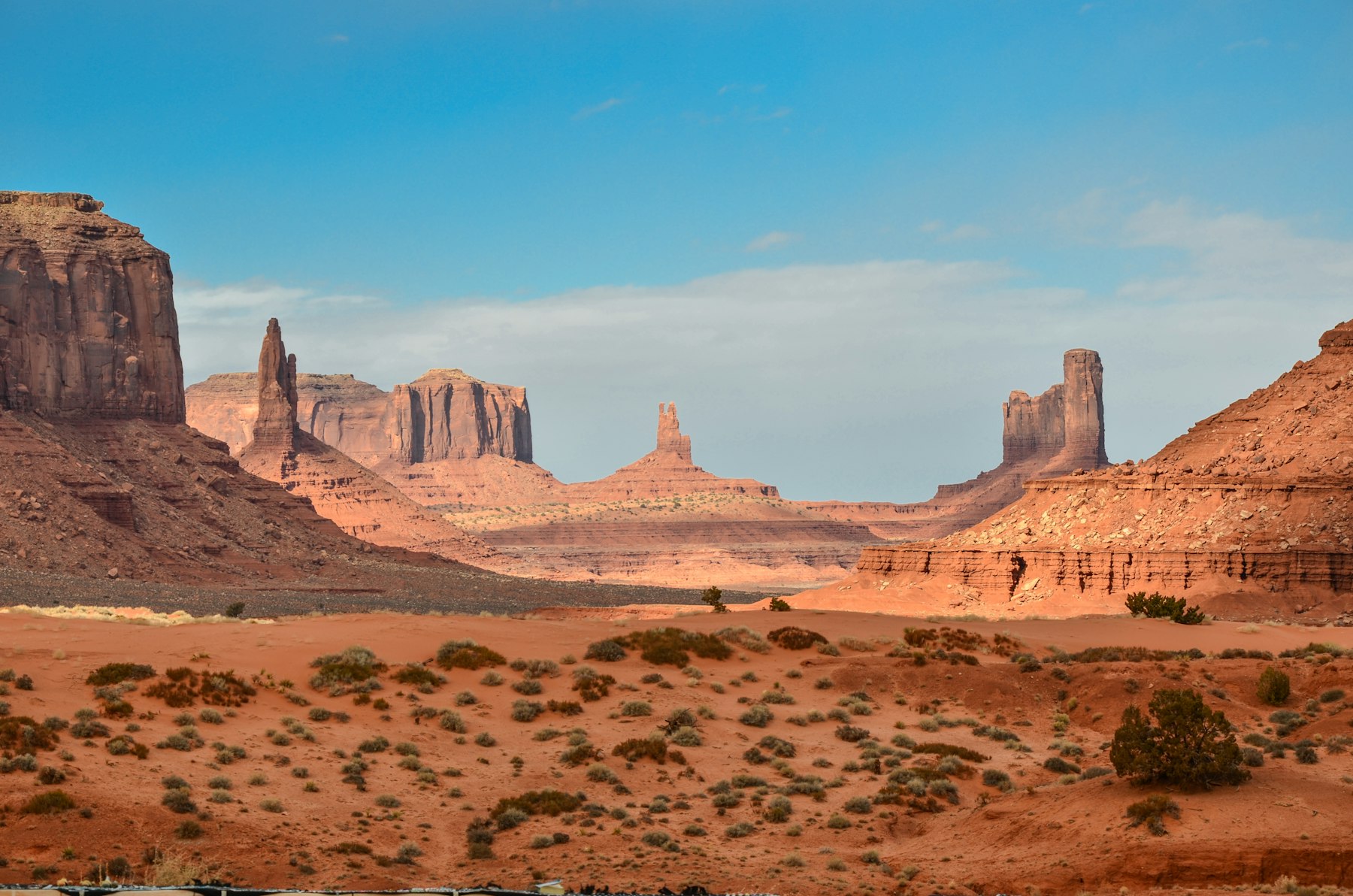 Red sandstone buttes rising from the desert floor at Monument Valley