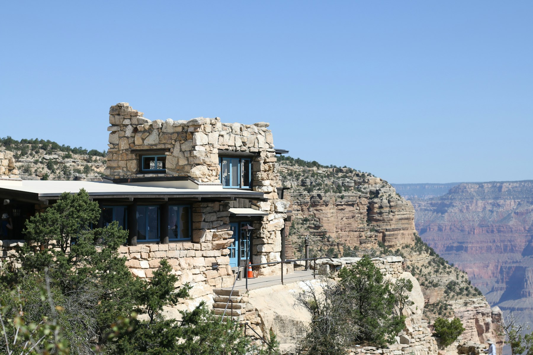 A historic stone building built on the very edge of the Grand Canyon rim