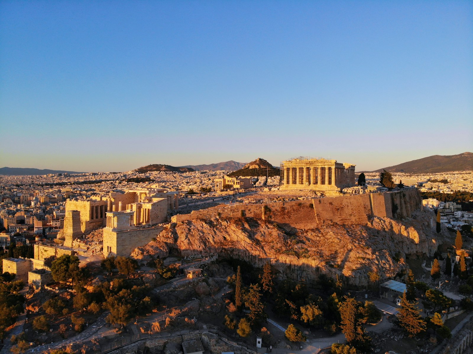 The Acropolis rising above the dense white rooftops of Athens under a clear sky