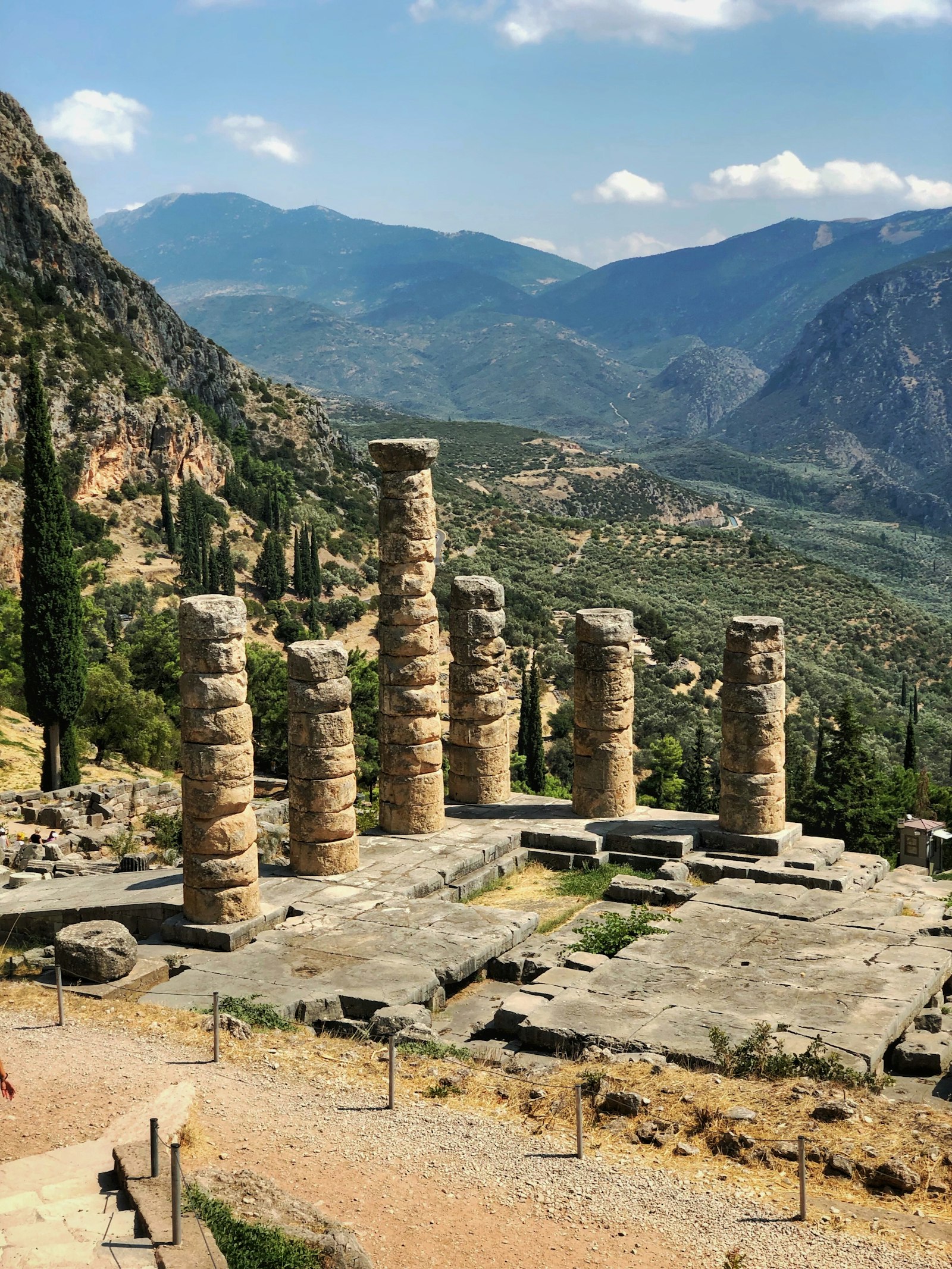 Standing columns of the Temple of Apollo at Delphi above a green valley