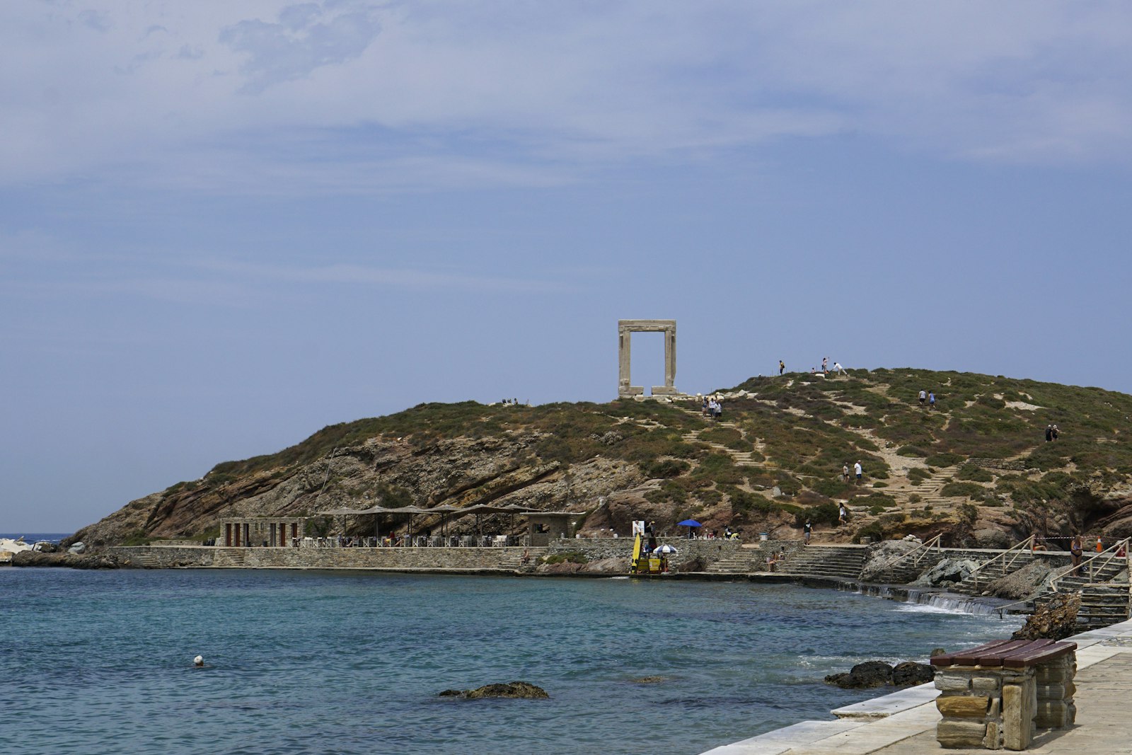 The stone Portara gateway standing alone on its islet beside the beach at Naxos