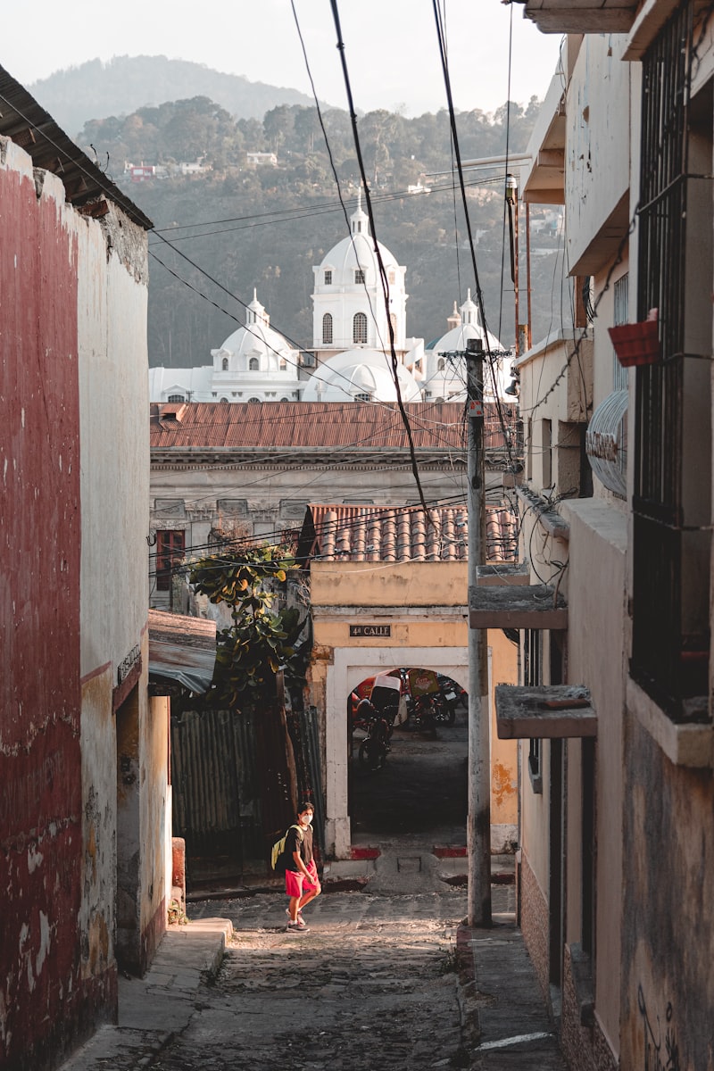 A narrow alley with a person walking in Quetzaltenango, Guatemala