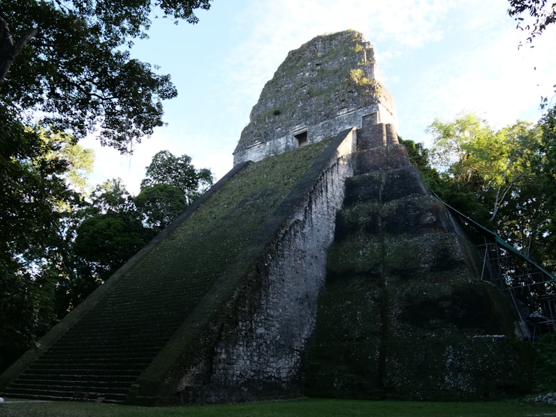 A tall stone pyramid with a steep stairway at Tikal National Park, Guatemala