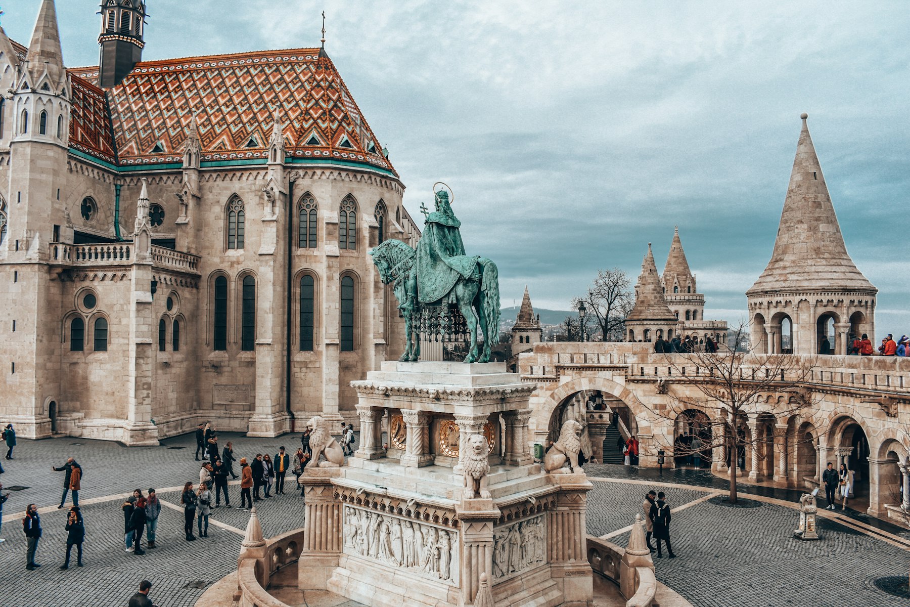 The white stone turrets and arcades of Fishermans Bastion in Budapest with the statue of King Stephen on horseback