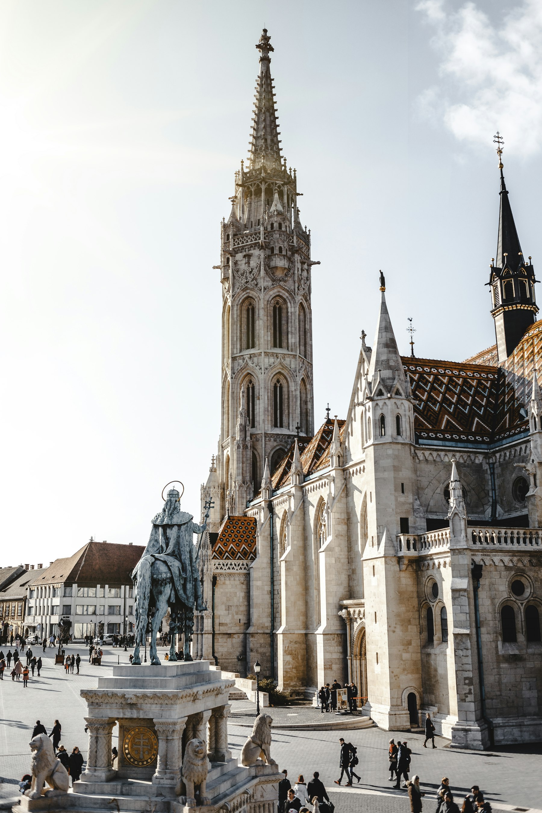The tiled roof and stone spire of Matthias Church rising above the Buda Castle district in Budapest