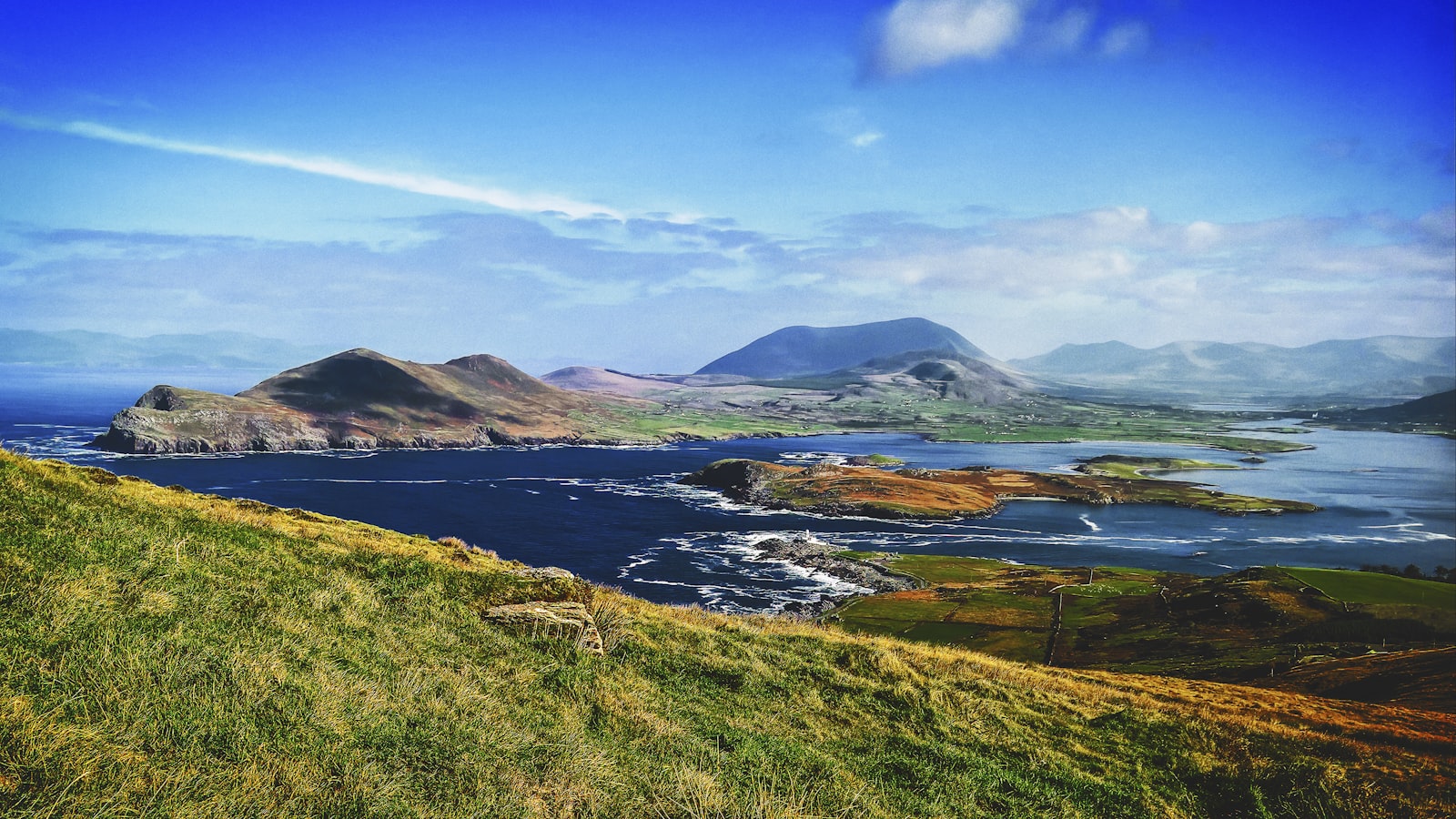 Green hills and small lakes running down to the Atlantic on the southwest coast of Ireland