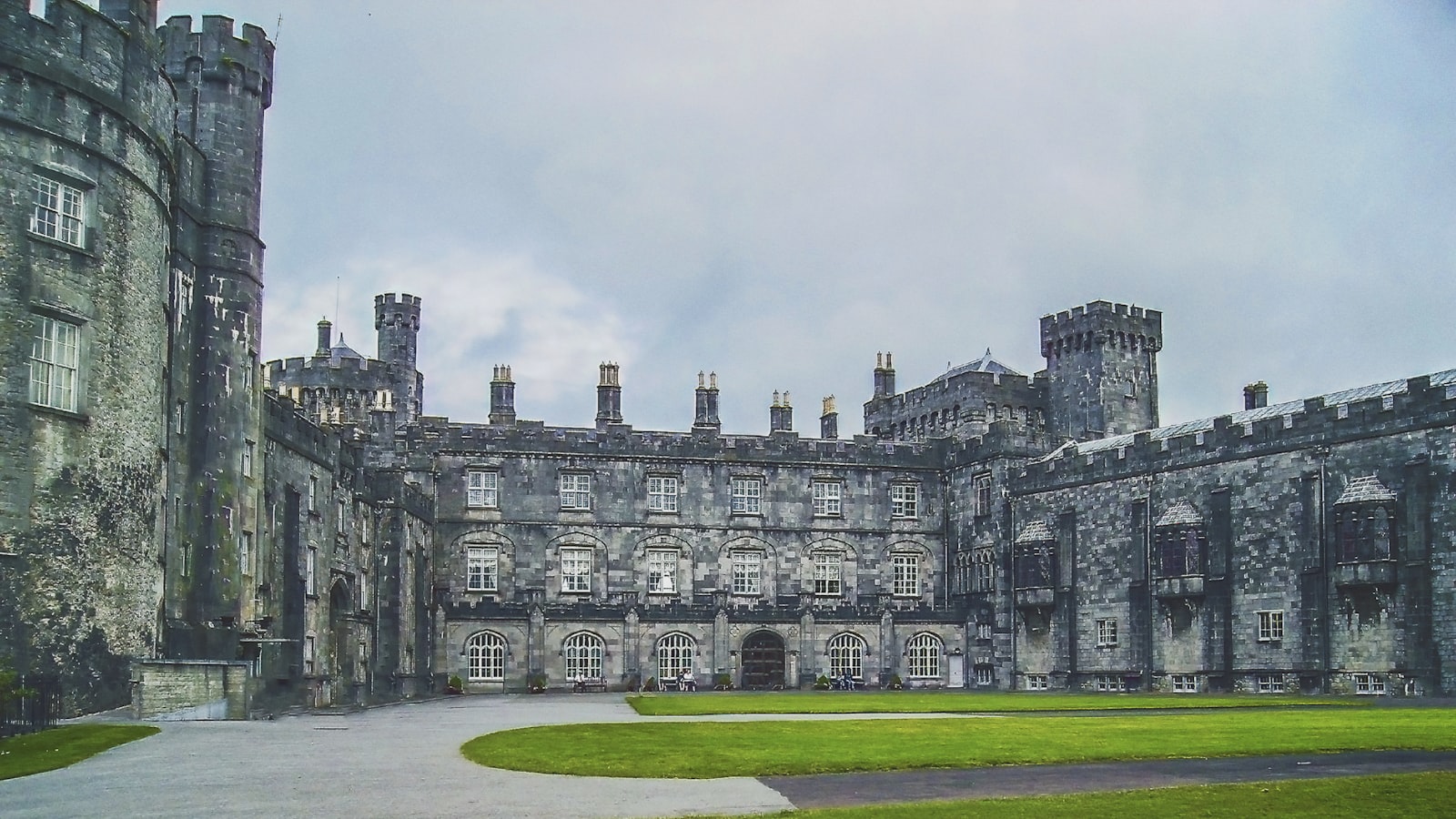 The grey stone frontage of Kilkenny Castle with its lawn in front