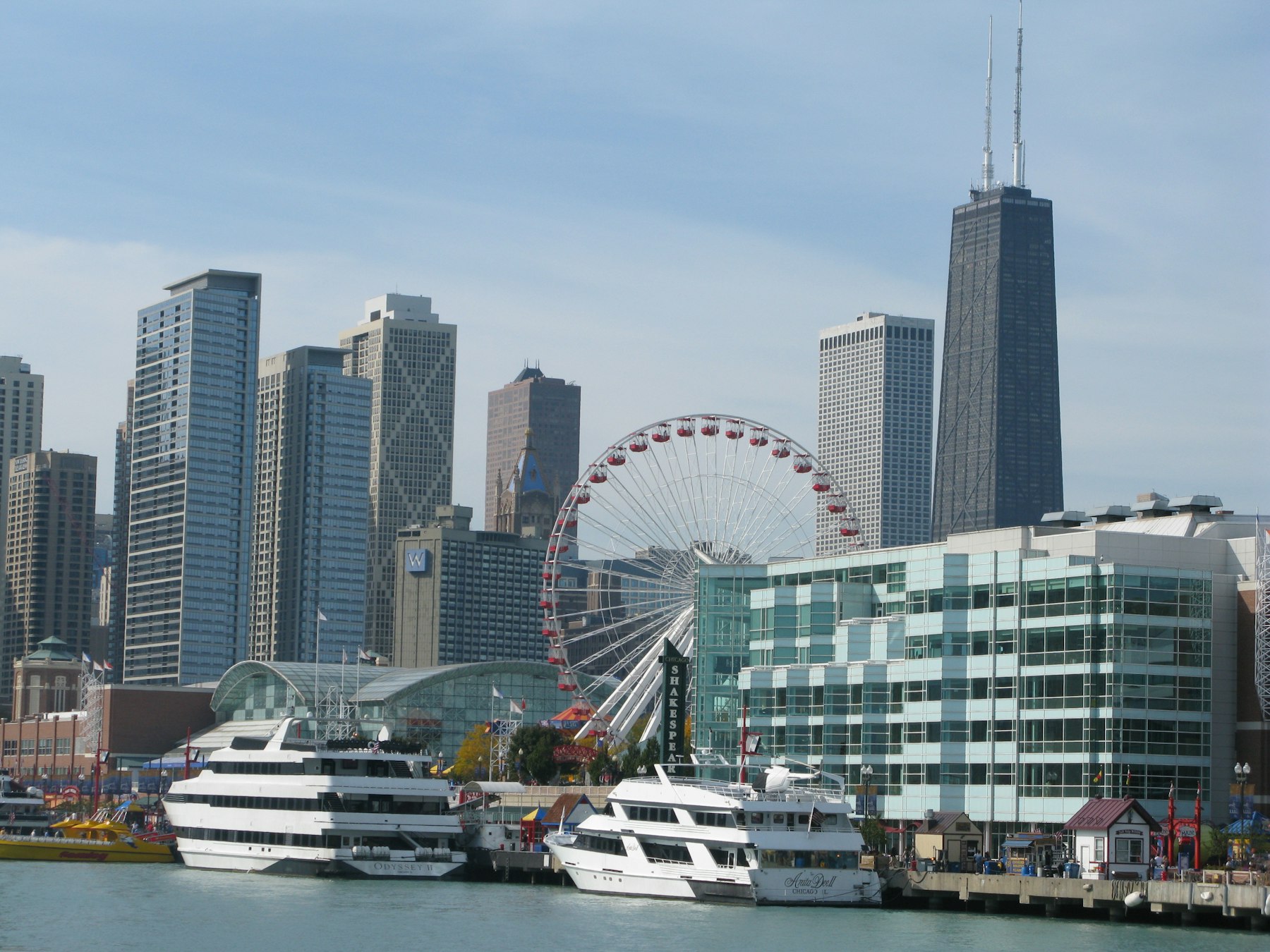 Navy Pier in Chicago with the Centennial Wheel and moored boats below the city skyline