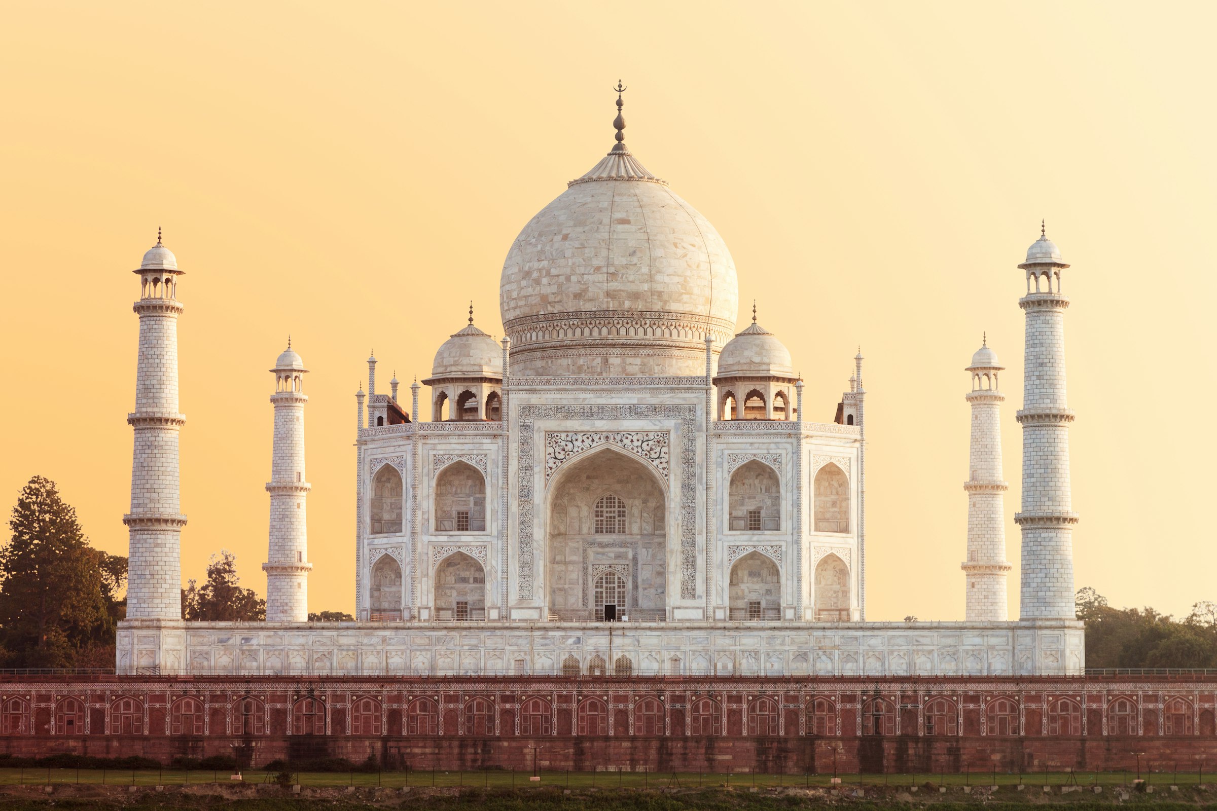 The Taj Mahal in Agra lit gold by low evening sun