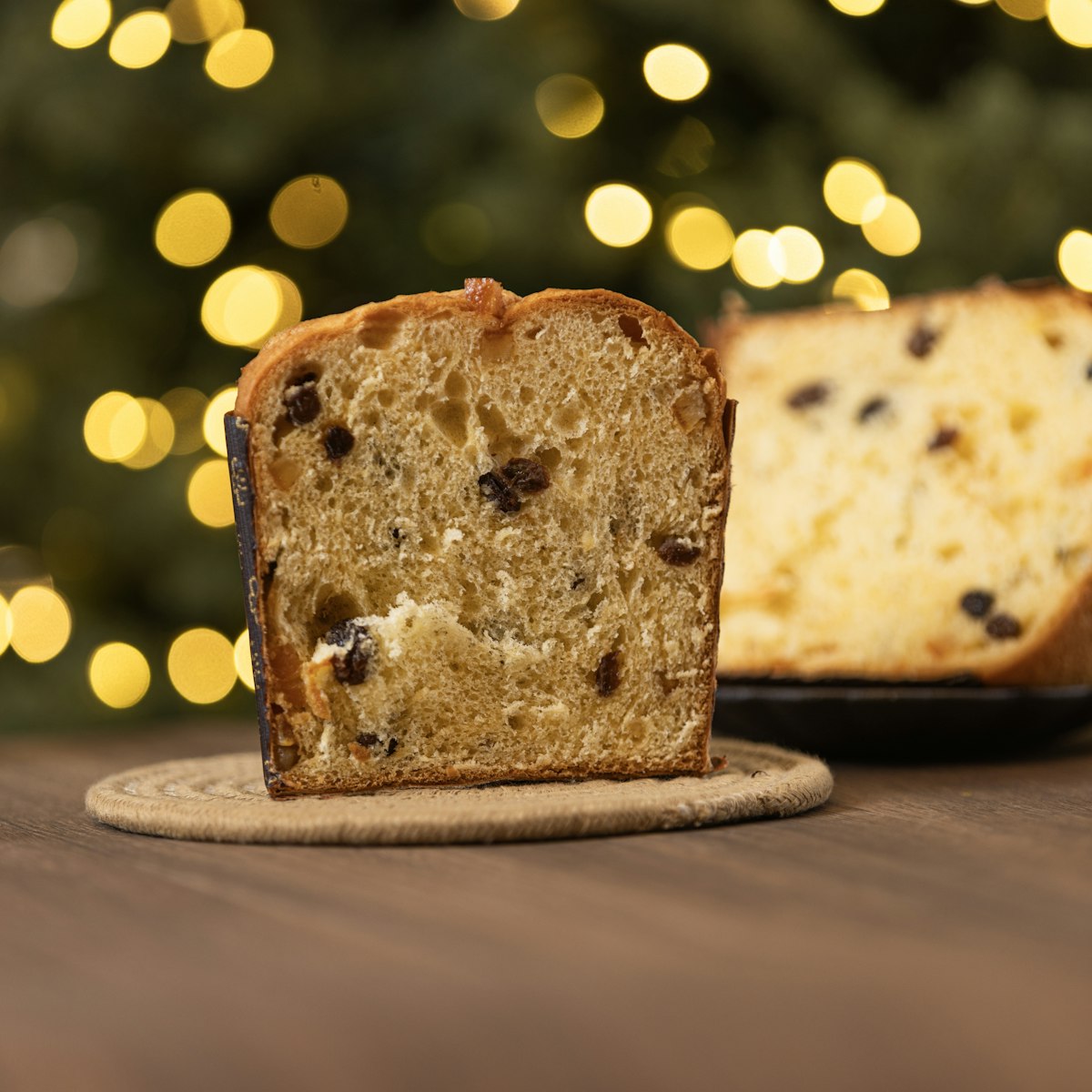 A slice of golden fruit studded cake on a board