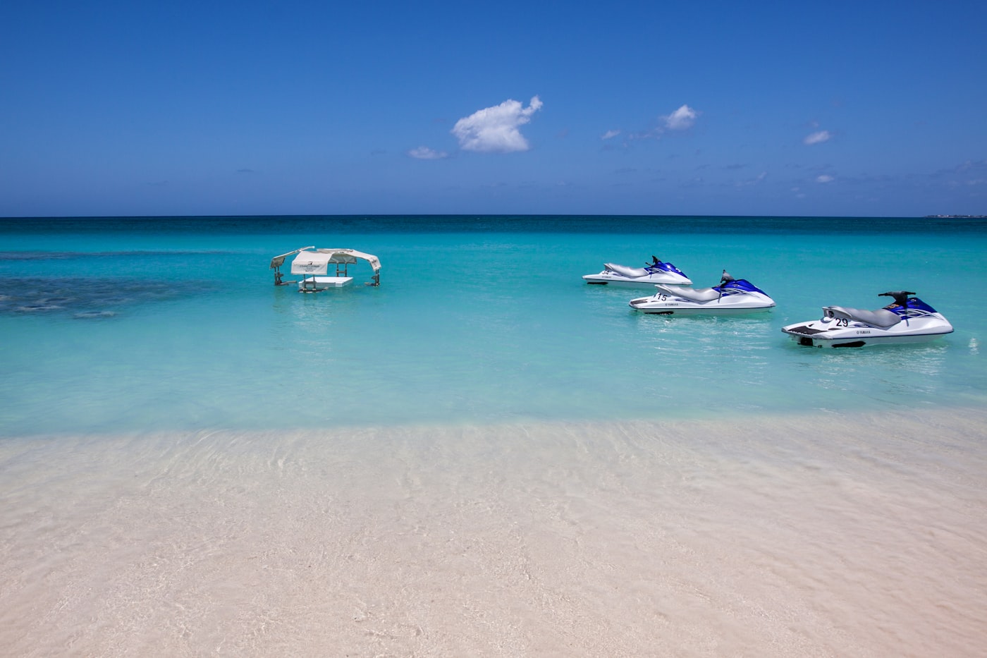 Jet skis moored in clear turquoise water off George Town on Grand Cayman