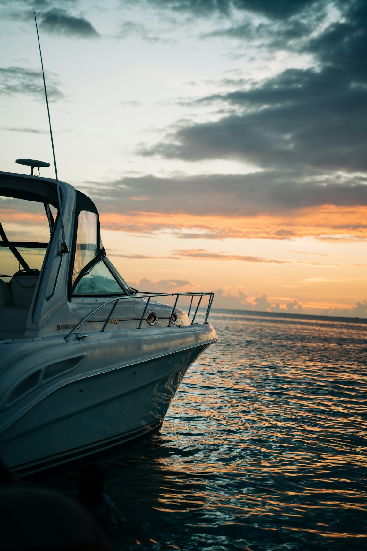 A small boat on flat water in the Cayman Islands at sunset