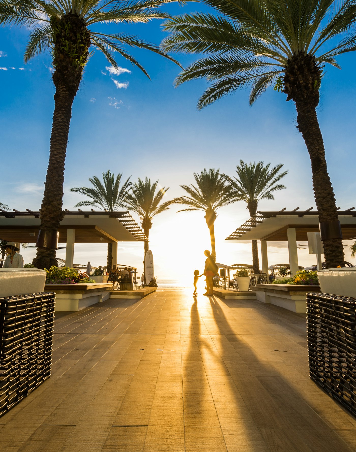 Palm trees and a beach pavilion at sunset on Seven Mile Beach, Grand Cayman