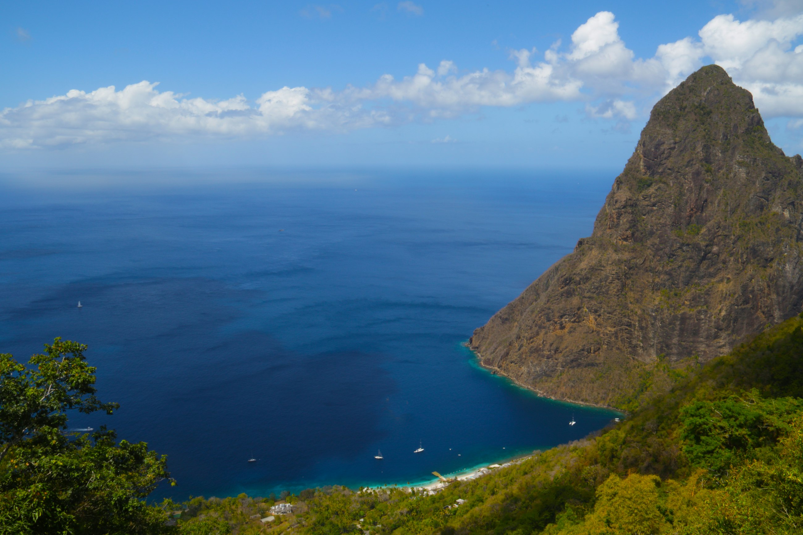 Gros Piton dropping into deep blue water seen from above on the south west coast of Saint Lucia