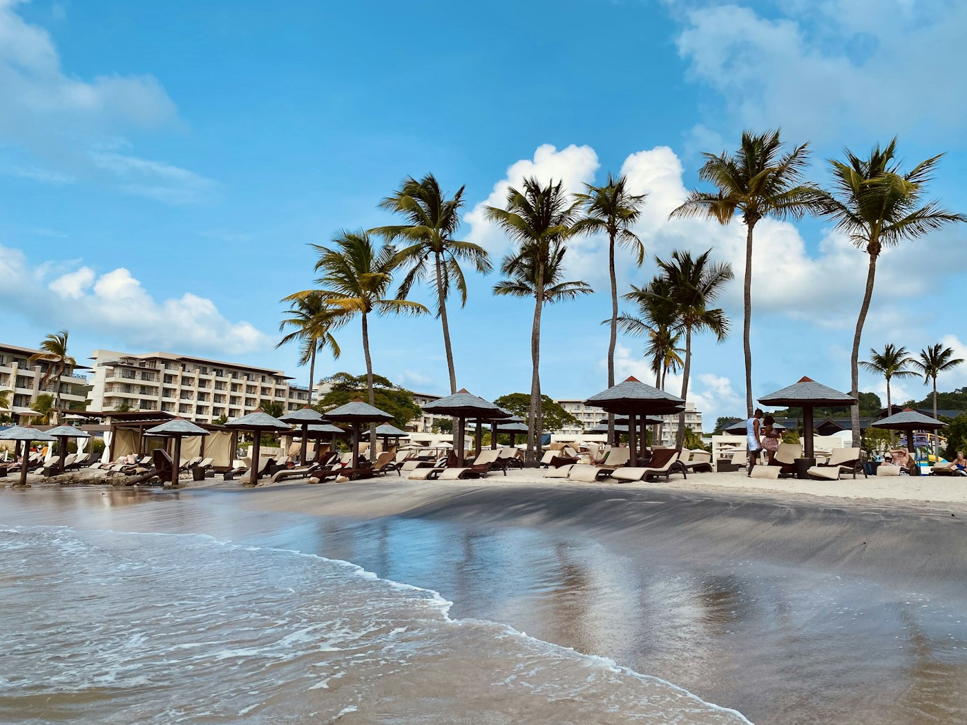 Palm trees and beach loungers along the resort strip at Rodney Bay on Saint Lucia