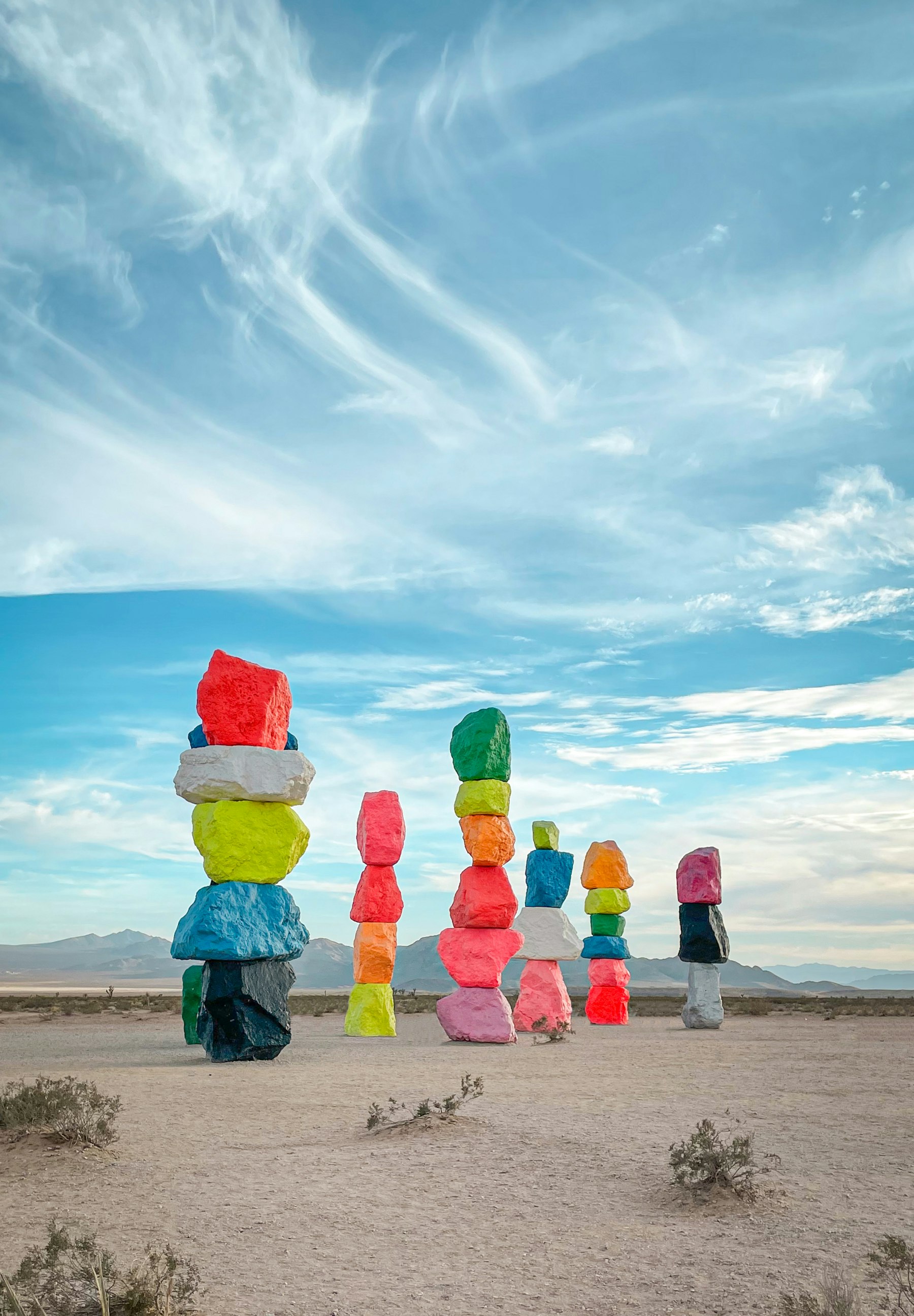The painted boulder towers of Seven Magic Mountains standing in open desert