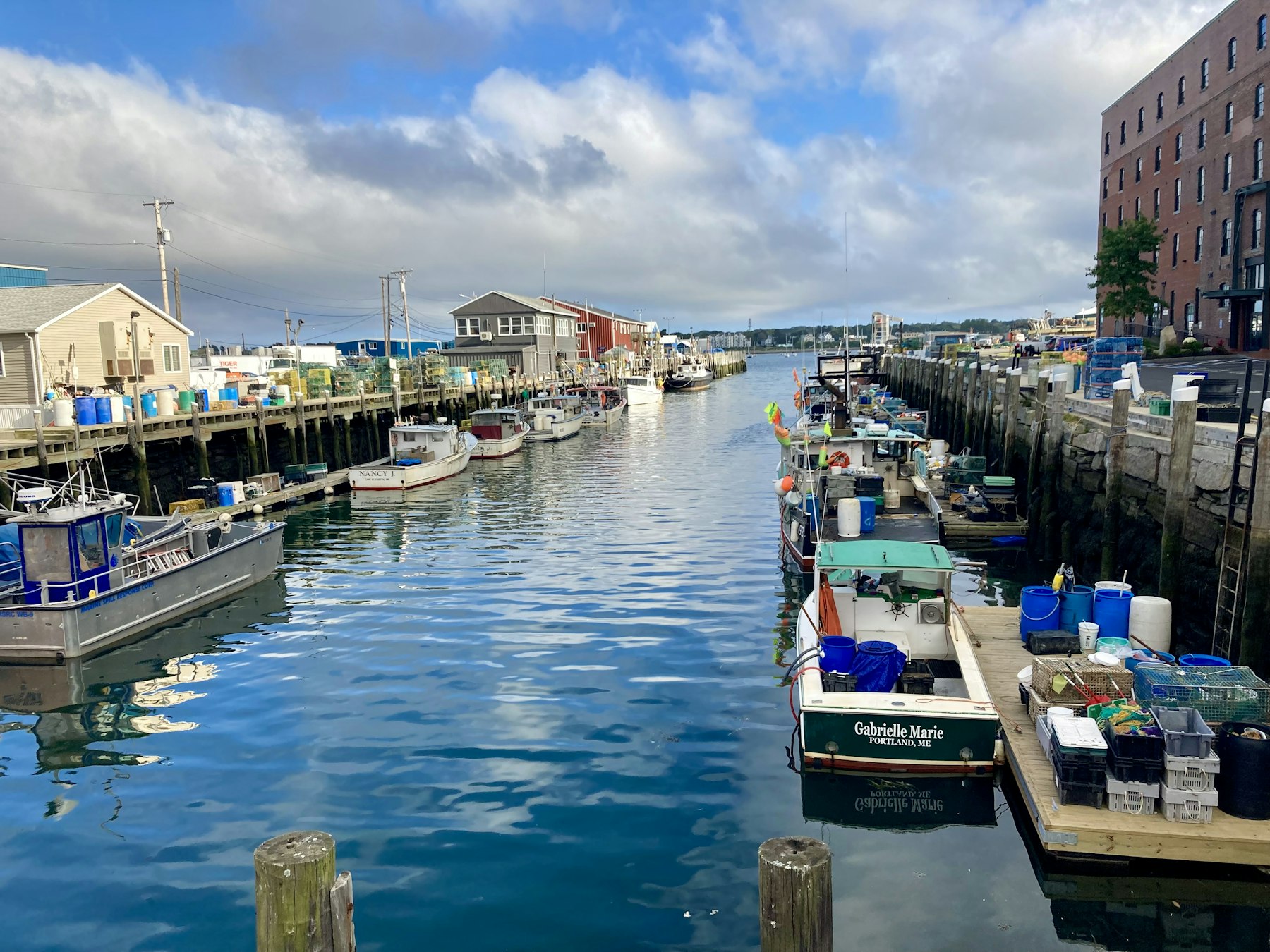 Fishing boats and brick warehouses along the working waterfront in Portland Maine