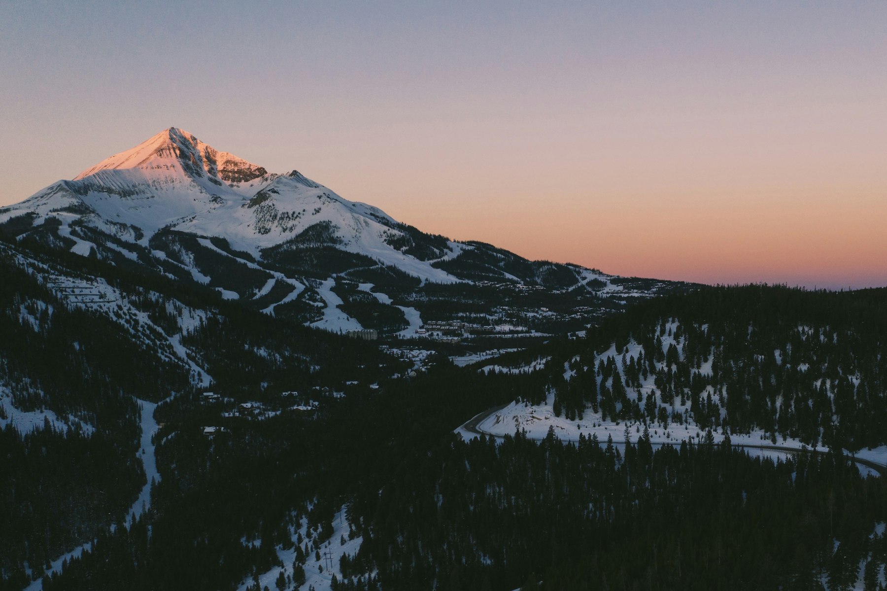 Lone Peak lit pink at sunset above Big Sky Montana