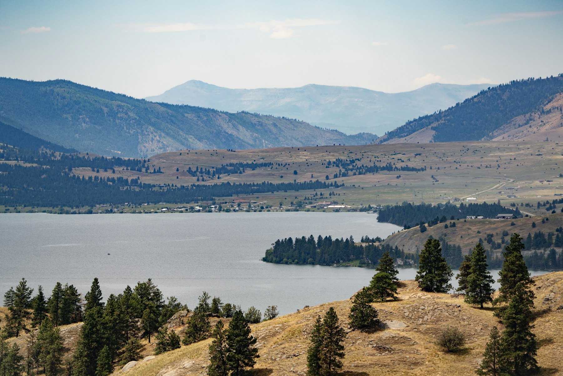 The long blue expanse of Flathead Lake with pine covered hills in Montana