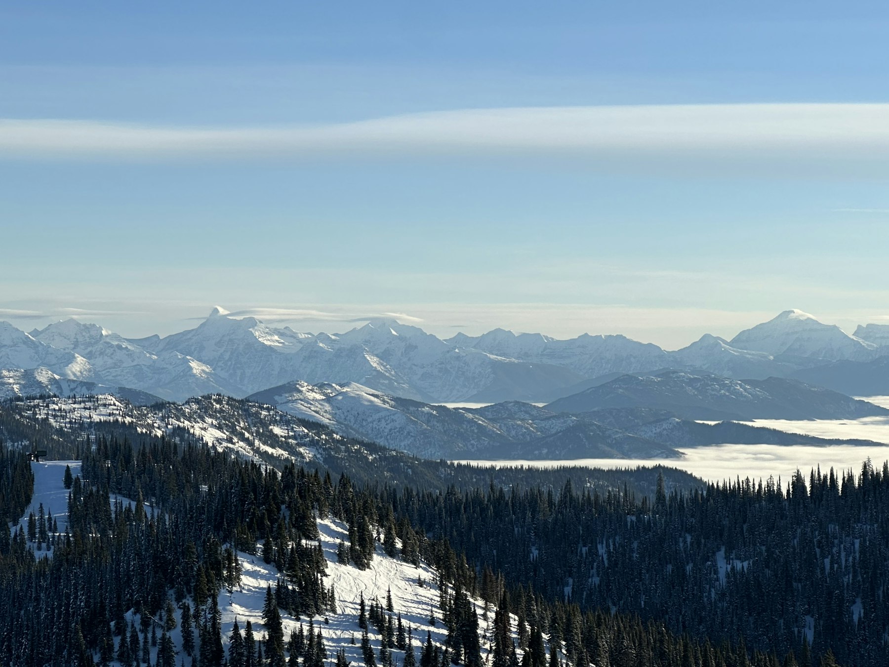 Snowy forested ski slopes above the Flathead Valley near Whitefish Montana