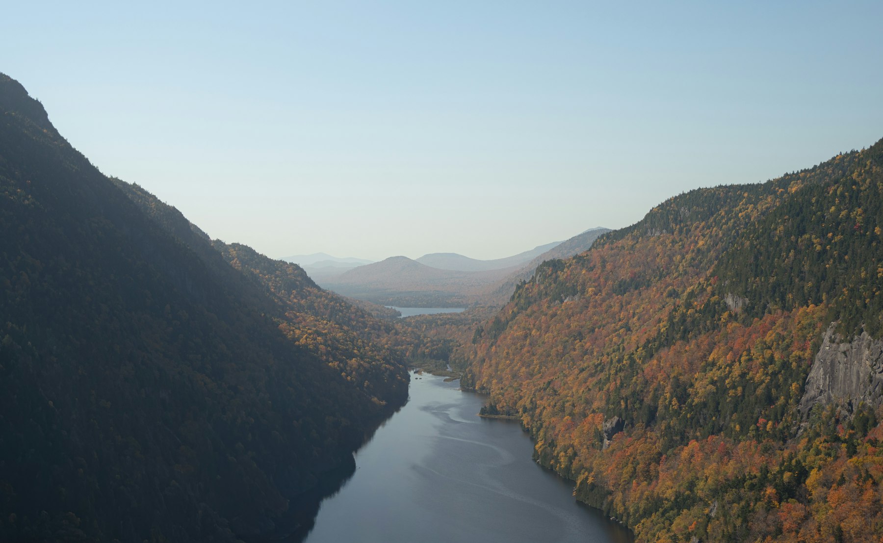 A river winding through a deep autumn valley in the Adirondack Mountains of New York